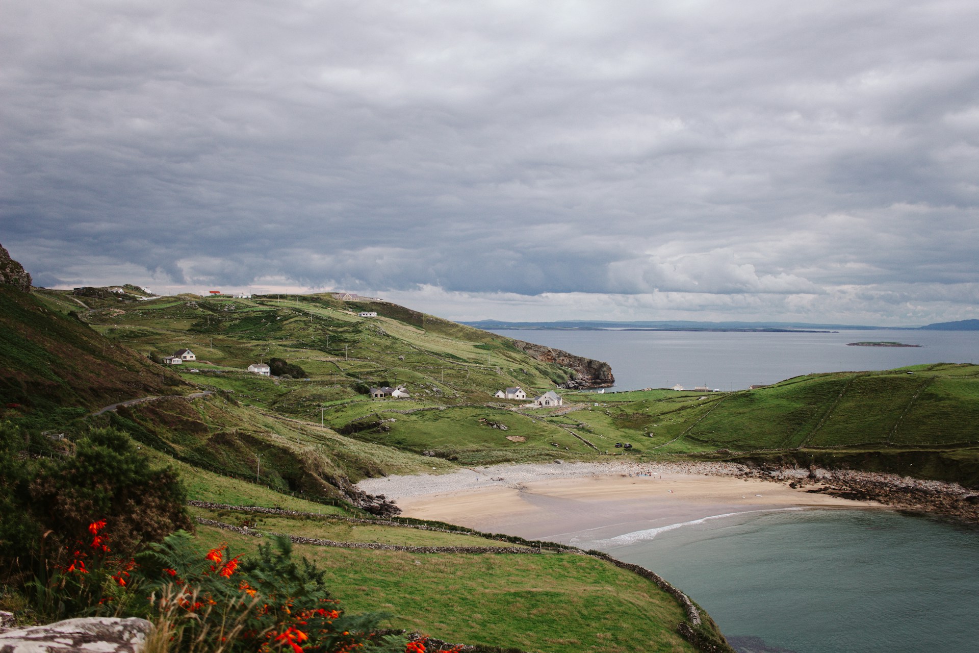 a-beach-with-a-body-of-water-by-it