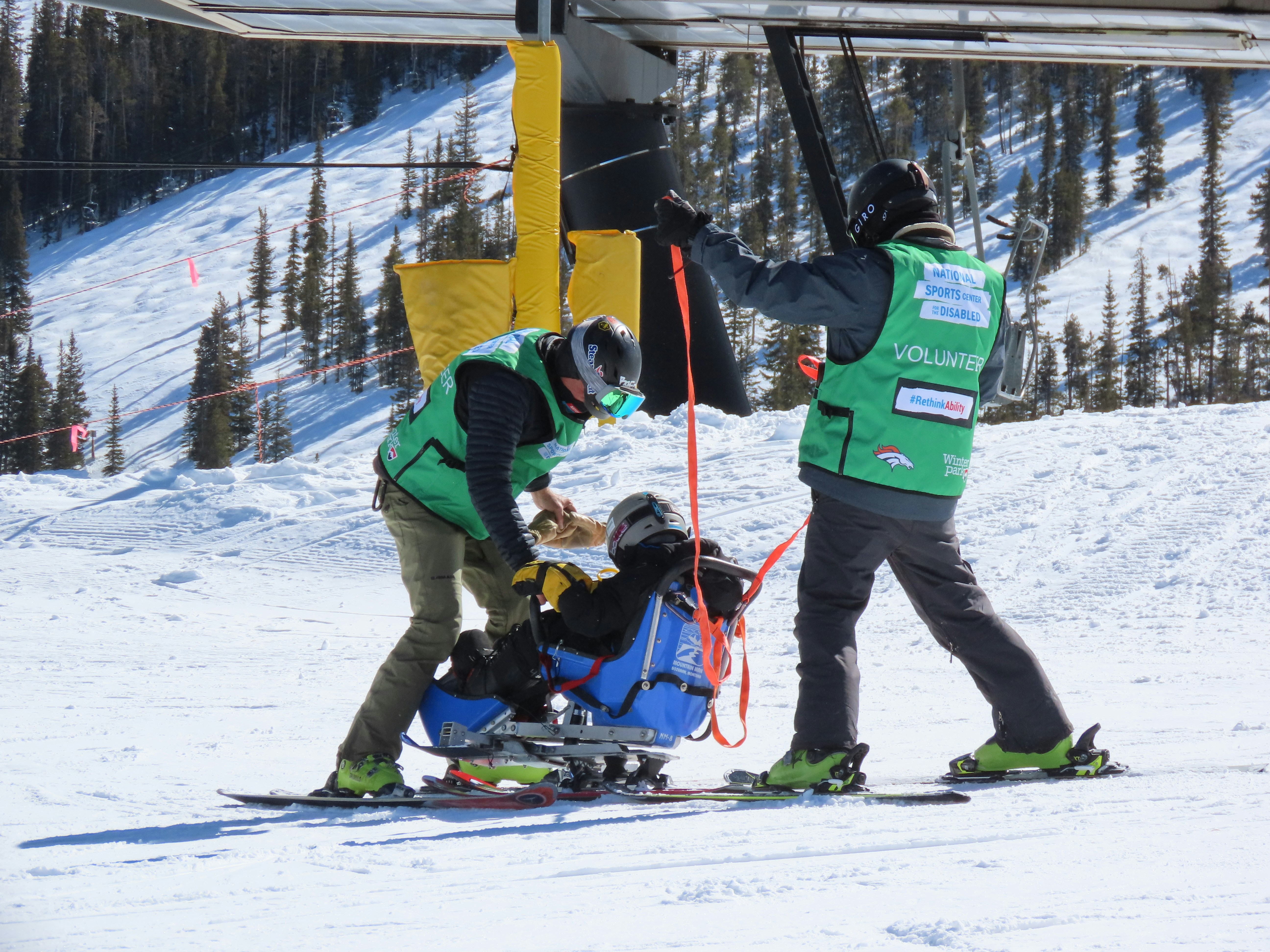 man-in-green-jacket-and-black-pants-standing-on-snow-covered-ground-during-daytime