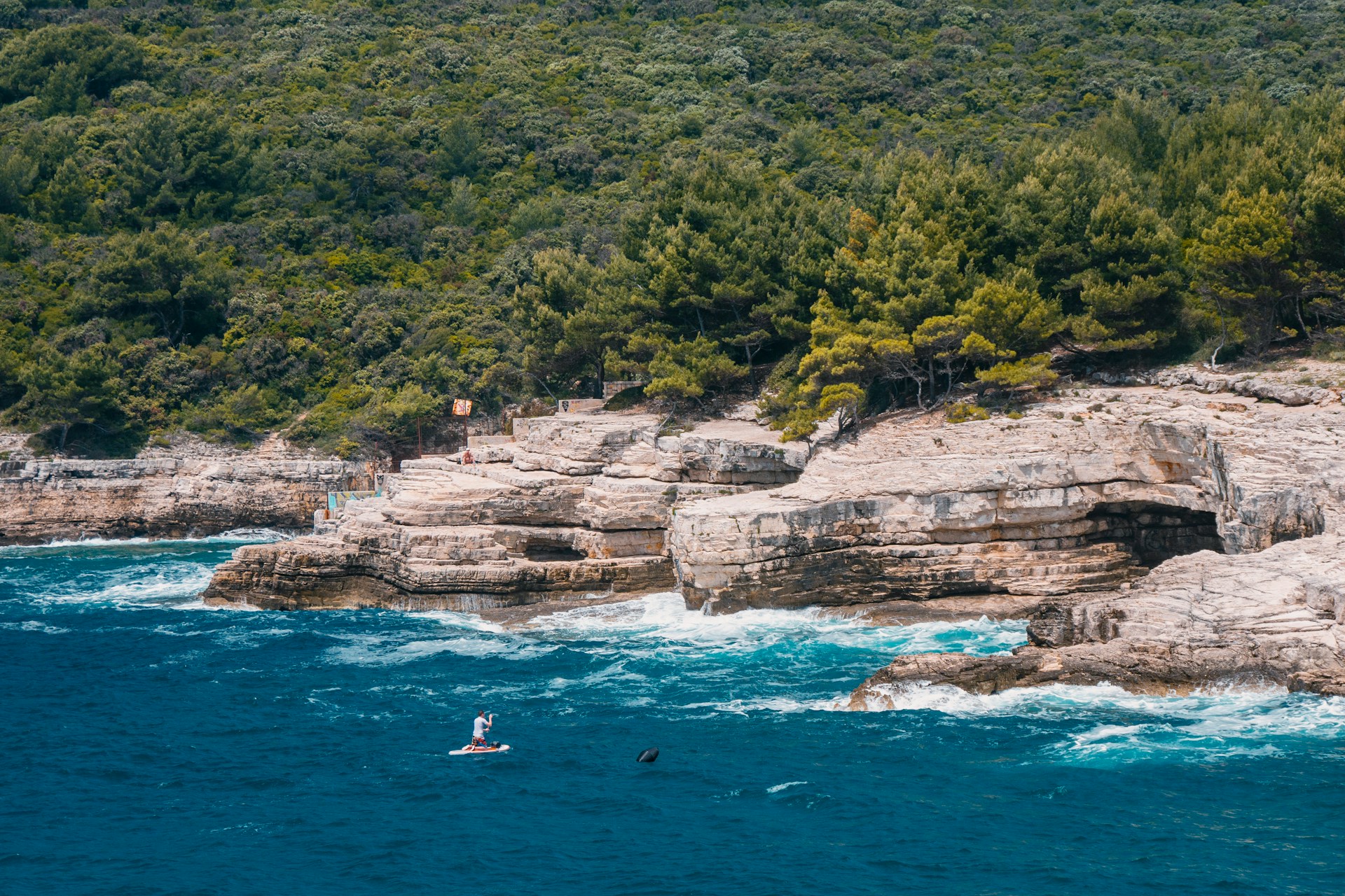 crystal-blue-sea-beside-rock-formation