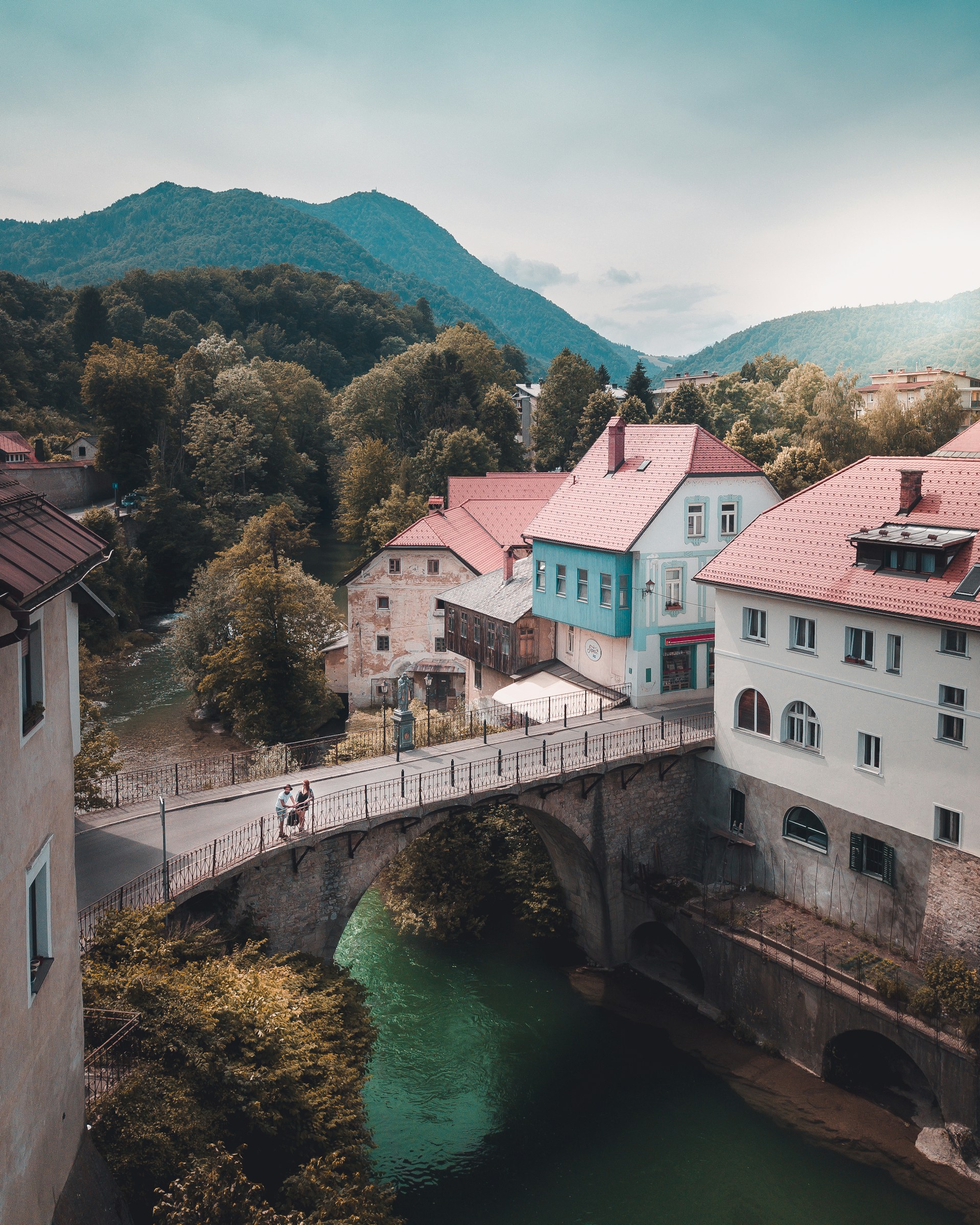 three-white-and-blue-concrete-house-near-brown-bridge
