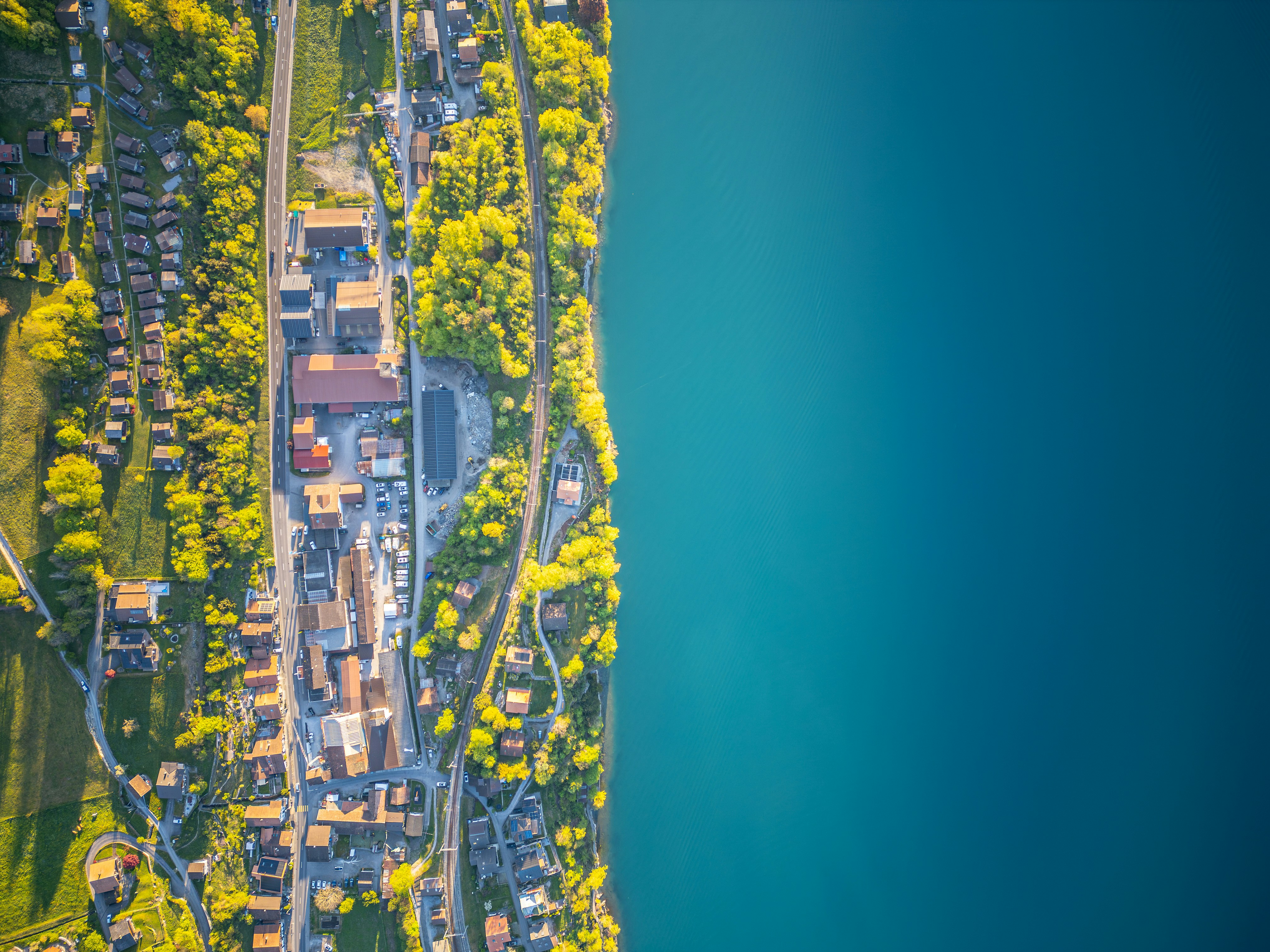 aerial-view-of-a-town-along-a-bright-blue-lake