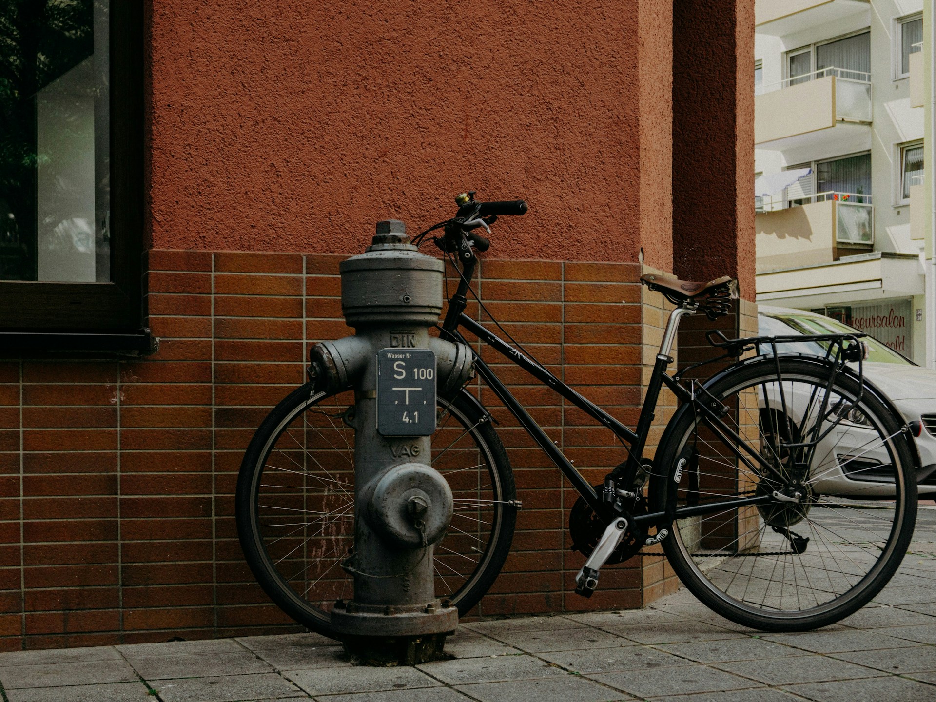 a-bicycle-is-parked-next-to-a-fire-hydrant
