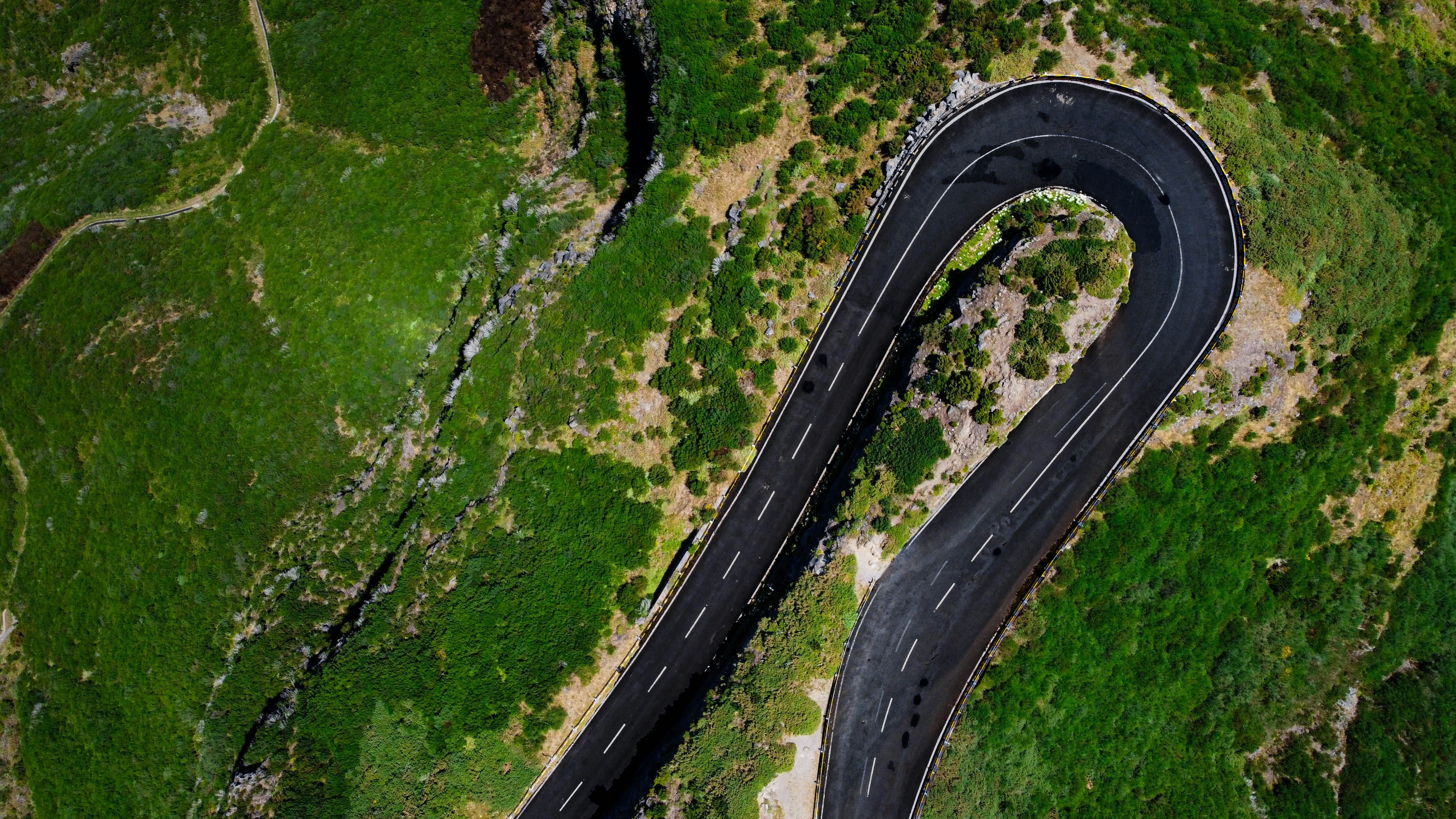an-aerial-view-of-a-winding-road-in-the-mountains