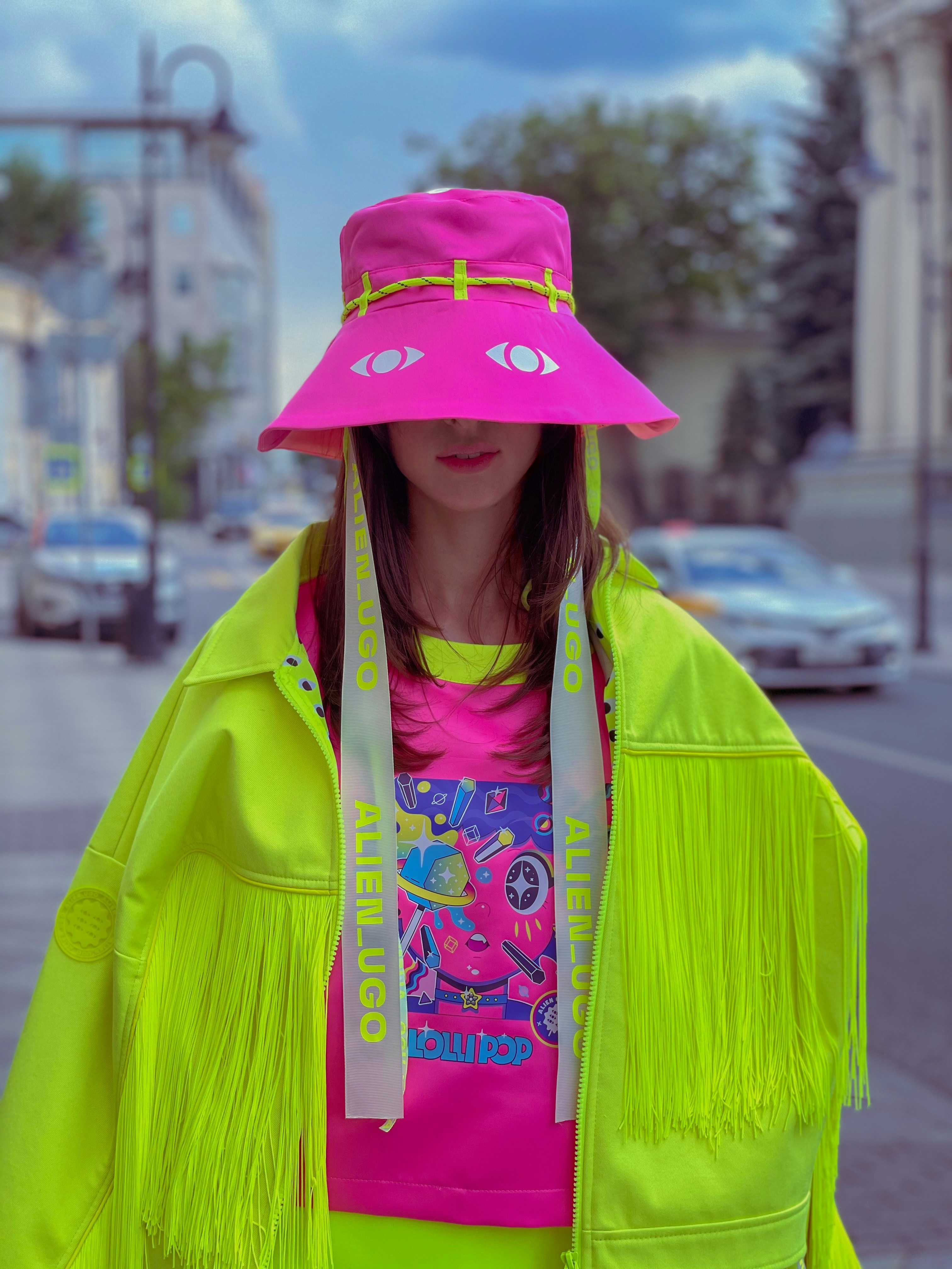 A person wearing brightly coloured contemporary fashion pieces stands outdoors, illustrating creativity, design and innovative approaches to fashion showcased at Green Fashion Week Milano 2026.
