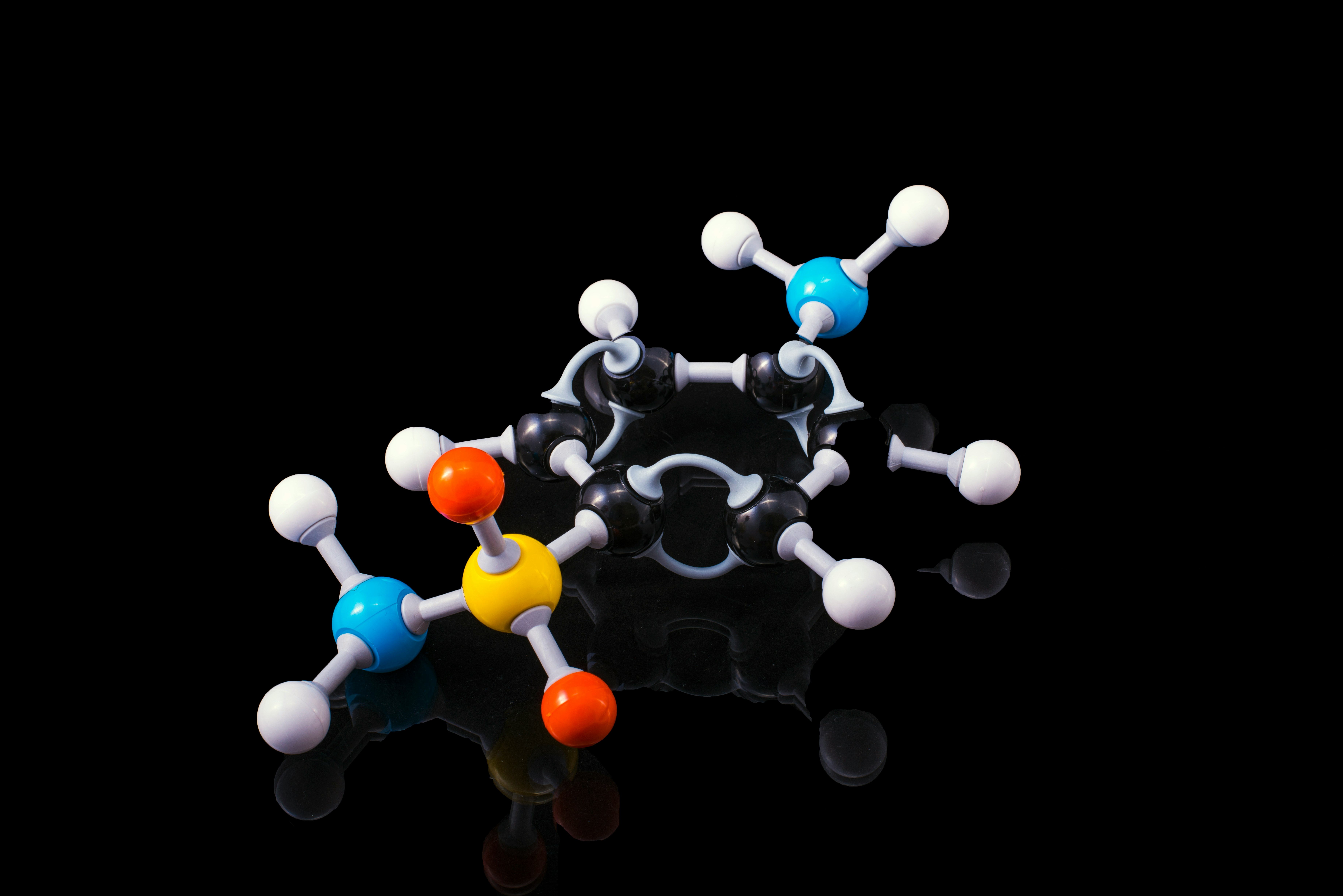 A molecule model with reflection on a dark surrounding.