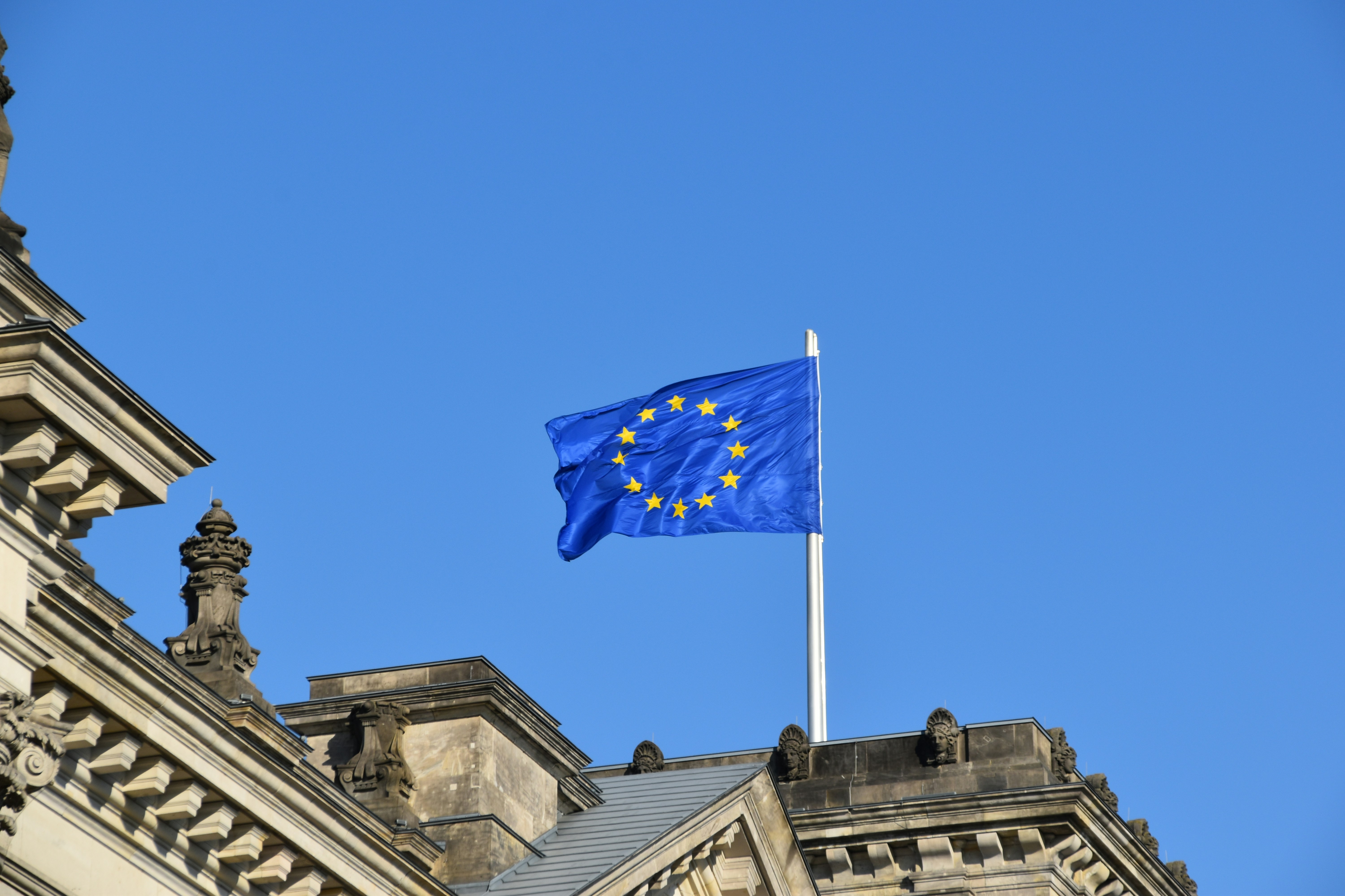 Waving blue and yellow EU flag.