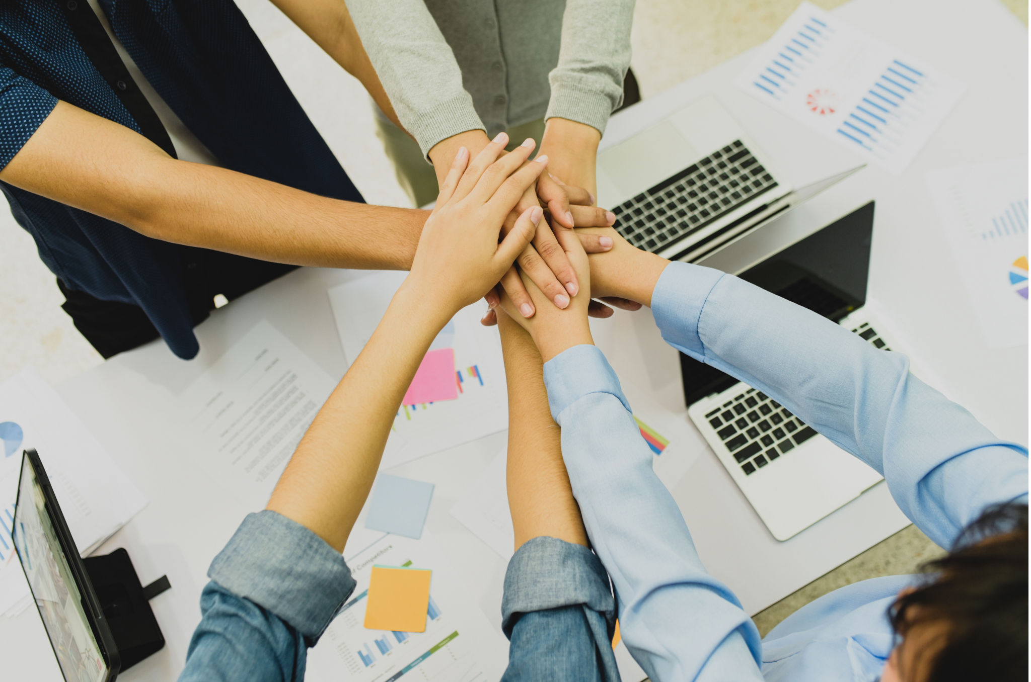 Image featuring a hand stack over a desk