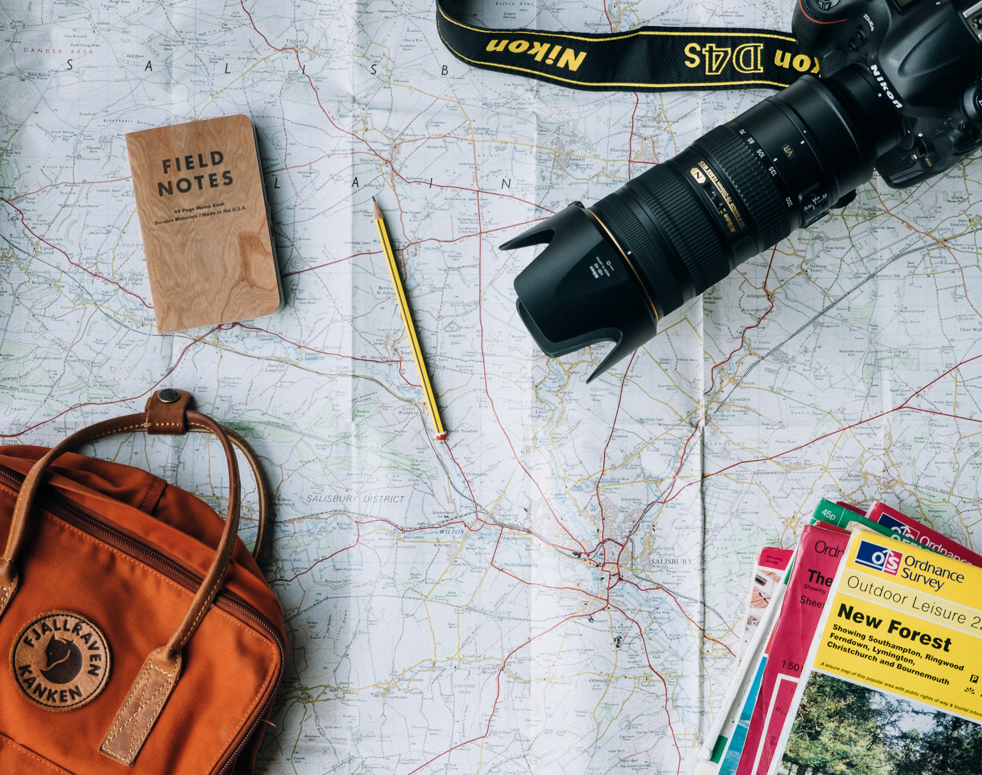 A picture presents travel items arranged on a map.