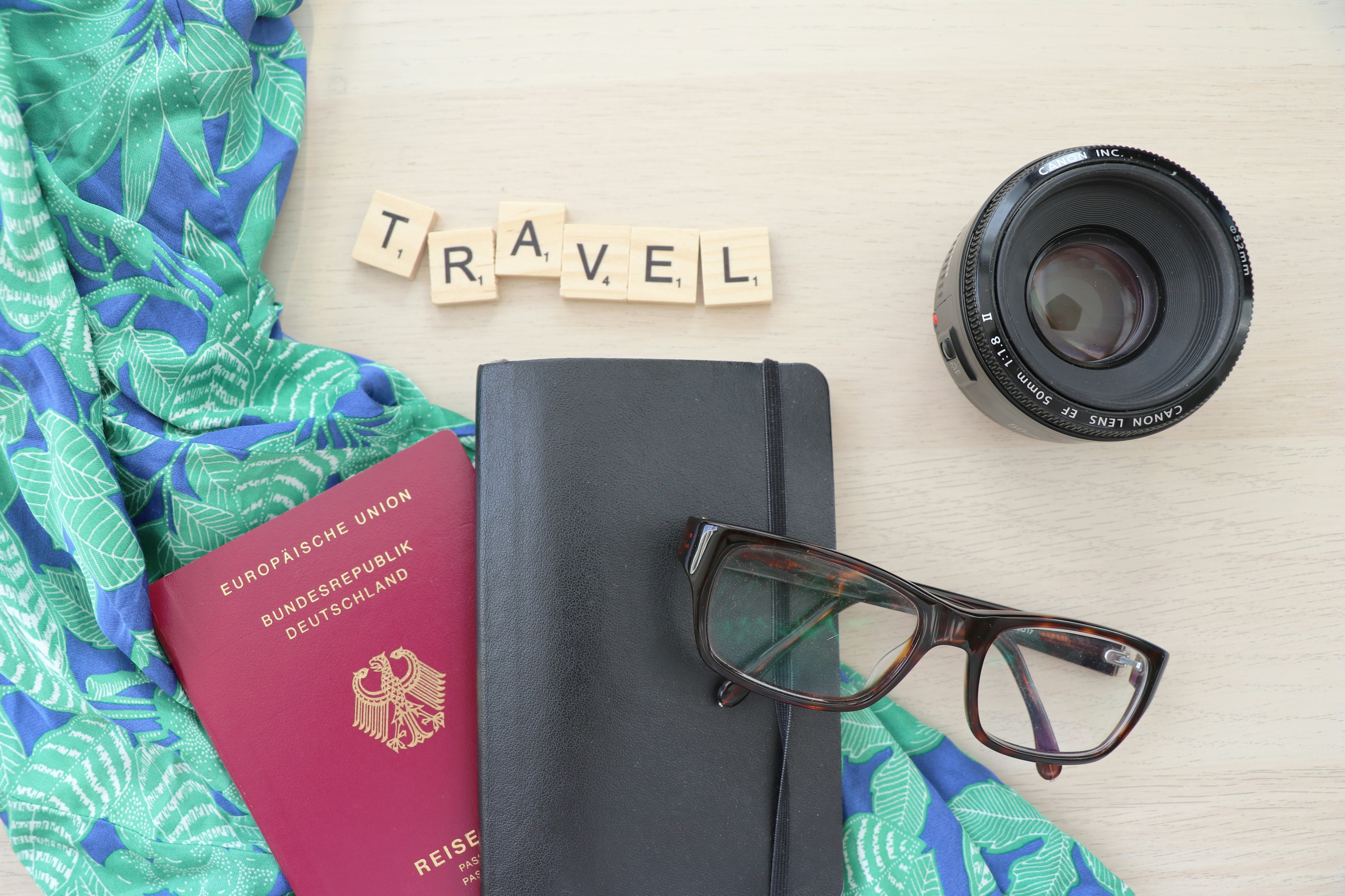 A picture presents travel essentials arranged on a table.