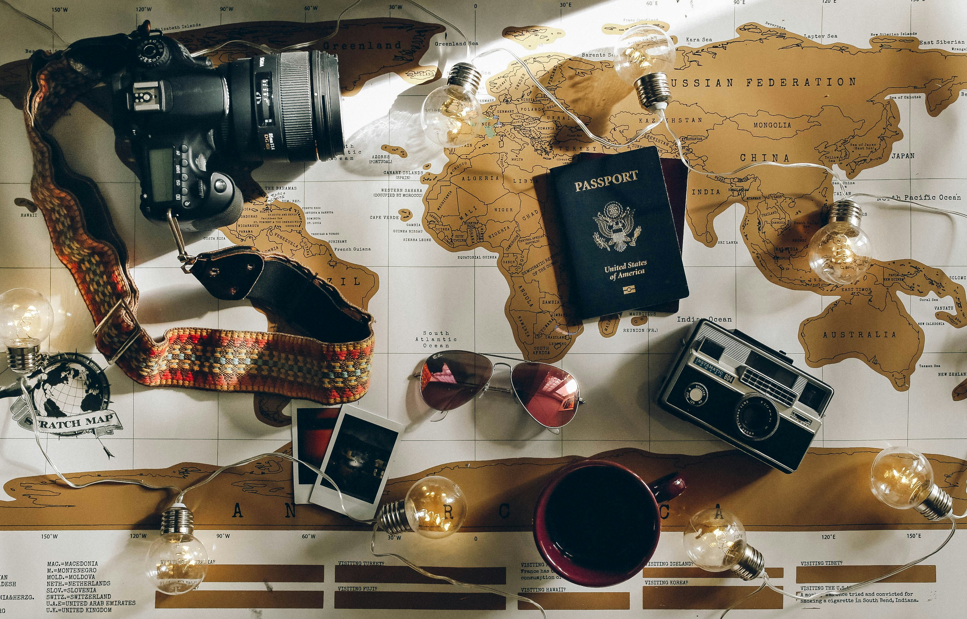 A photo of travel items arranged on a world map.