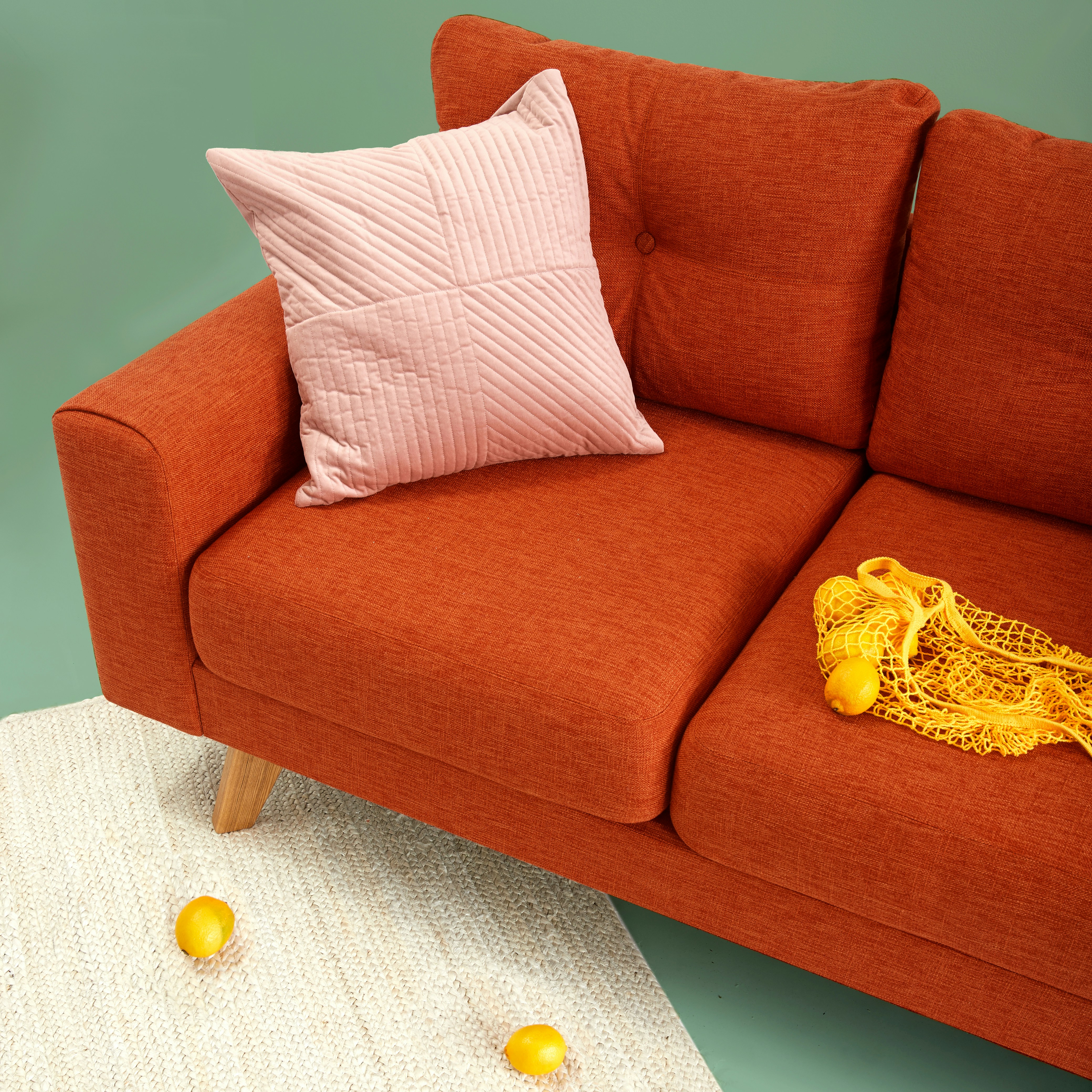 Modern sofa with upholstered textile fabric and decorative cushion, illustrating the use of high-quality textile materials in home furnishing and interior textiles.