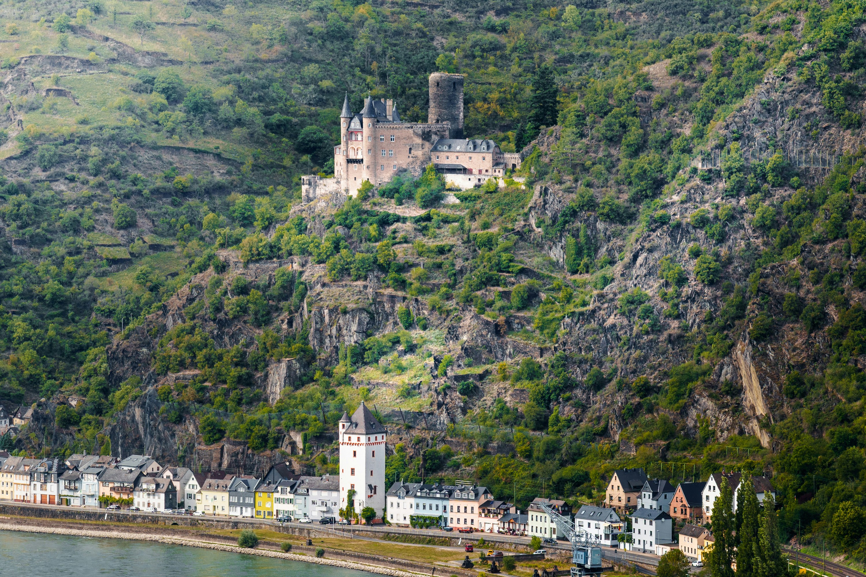 Castle ruins overlooking a river and village