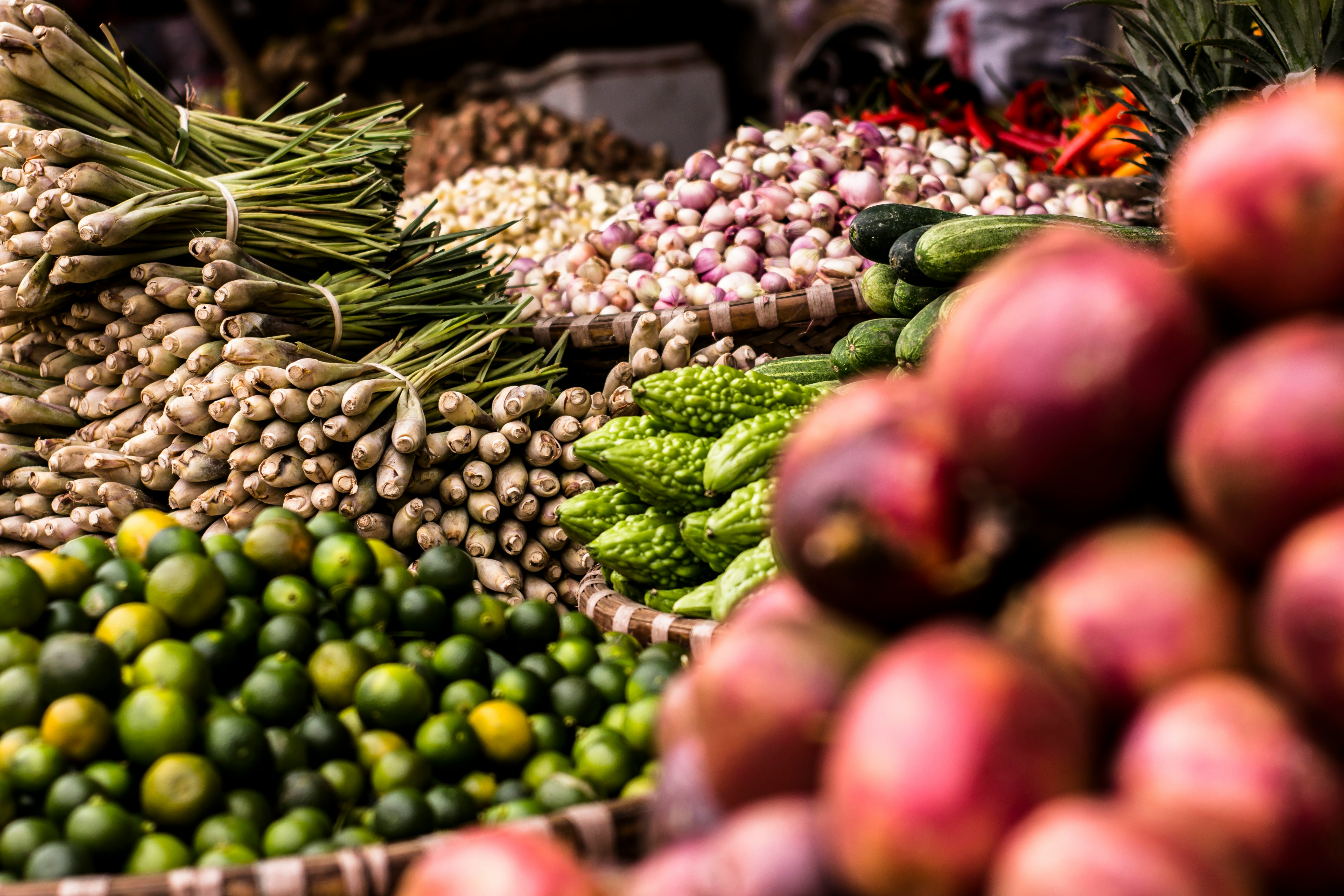 A picture presents a market stall filled with fresh fruits and vegetables.