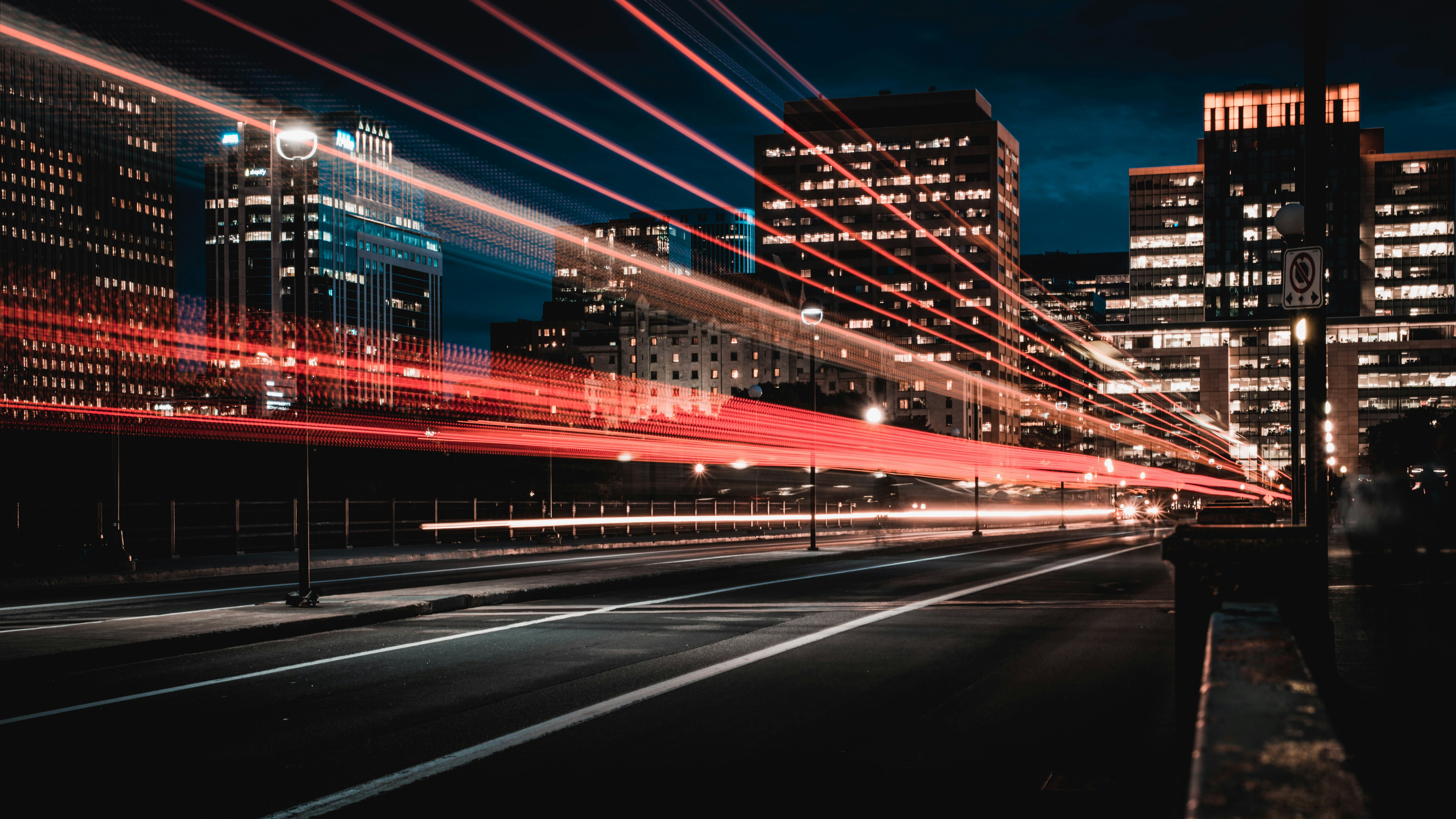 A picture presents a city street at night with light trails.