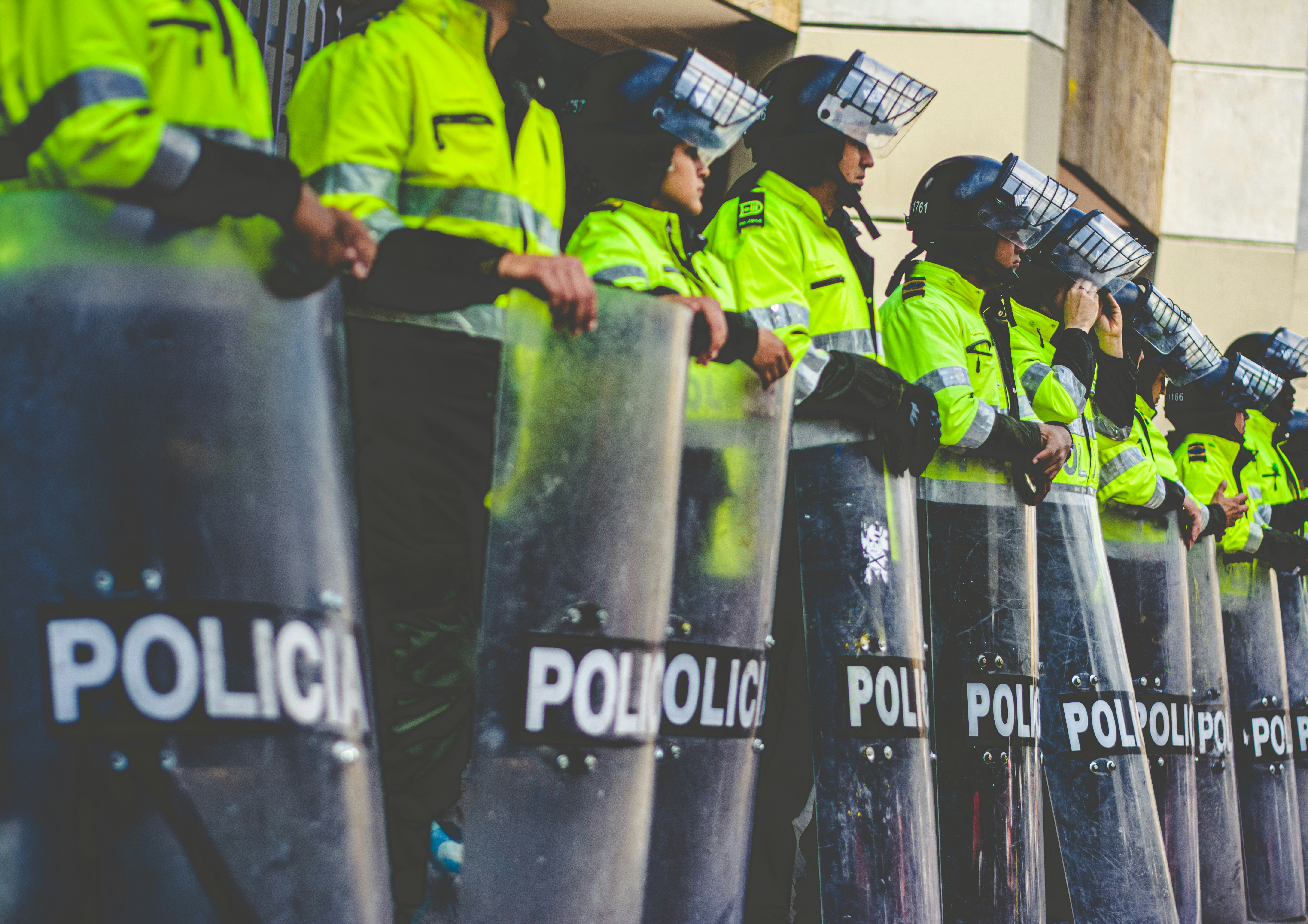 A row of police men standing next each other. 