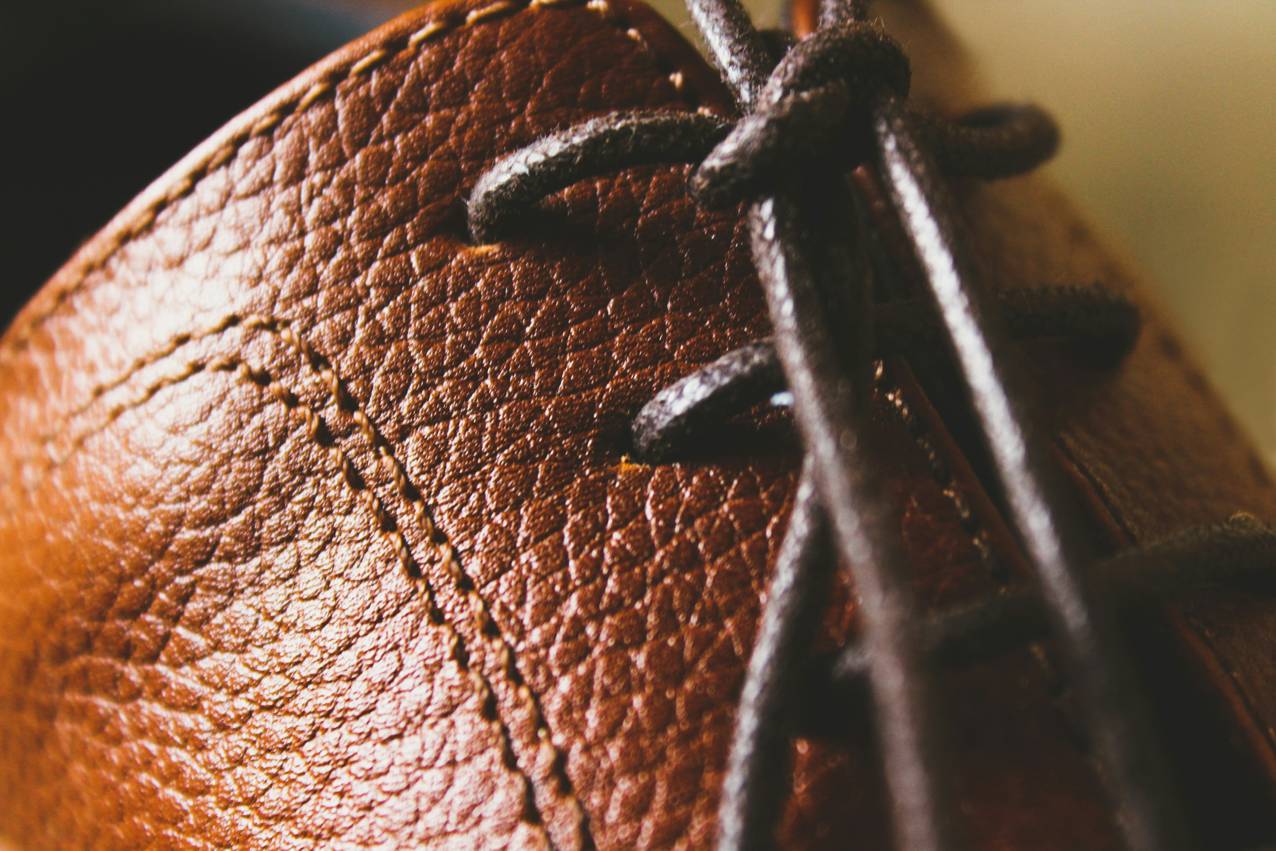 A close up of a brown leather shoe.