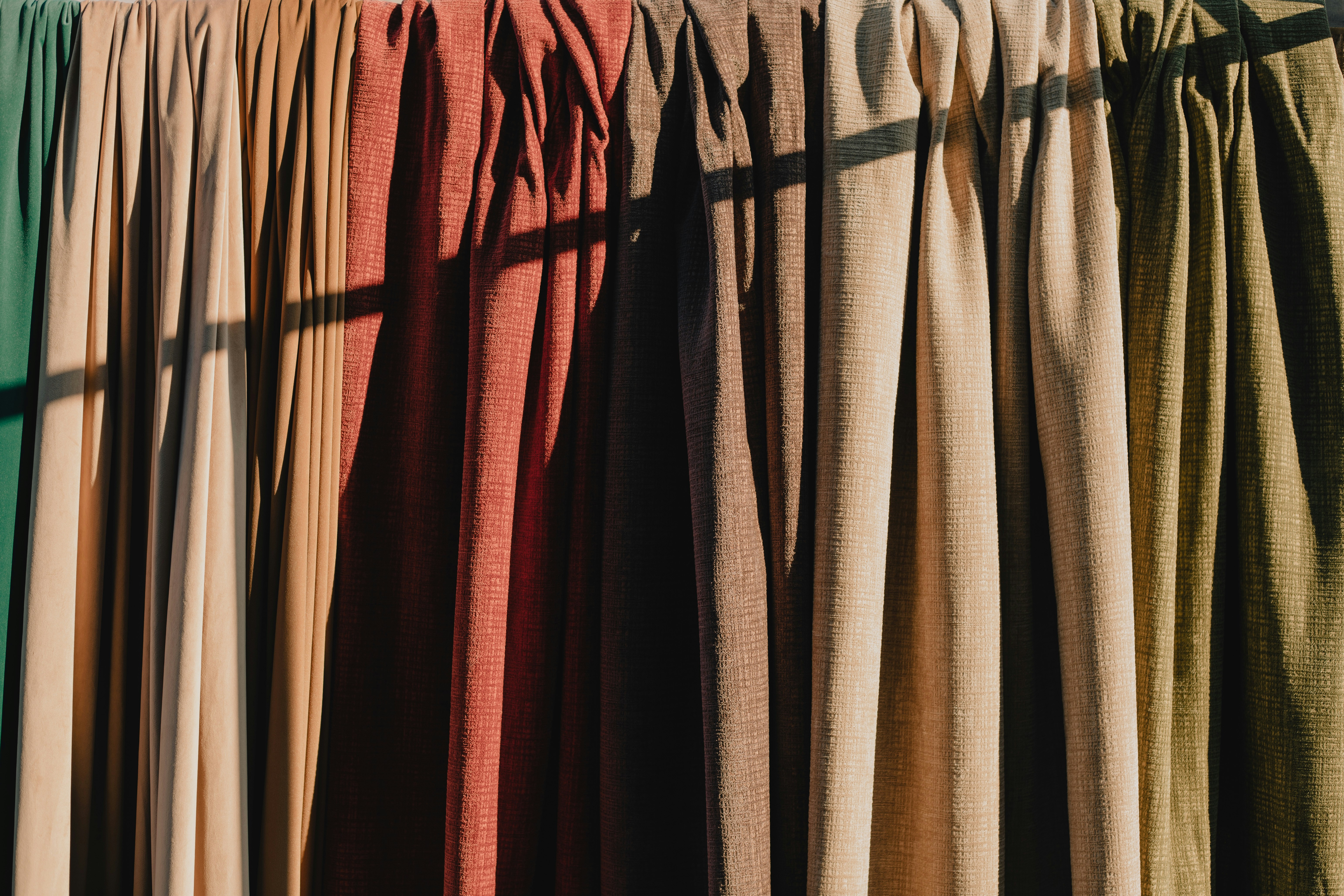 Different colours of curtains made from same textile.