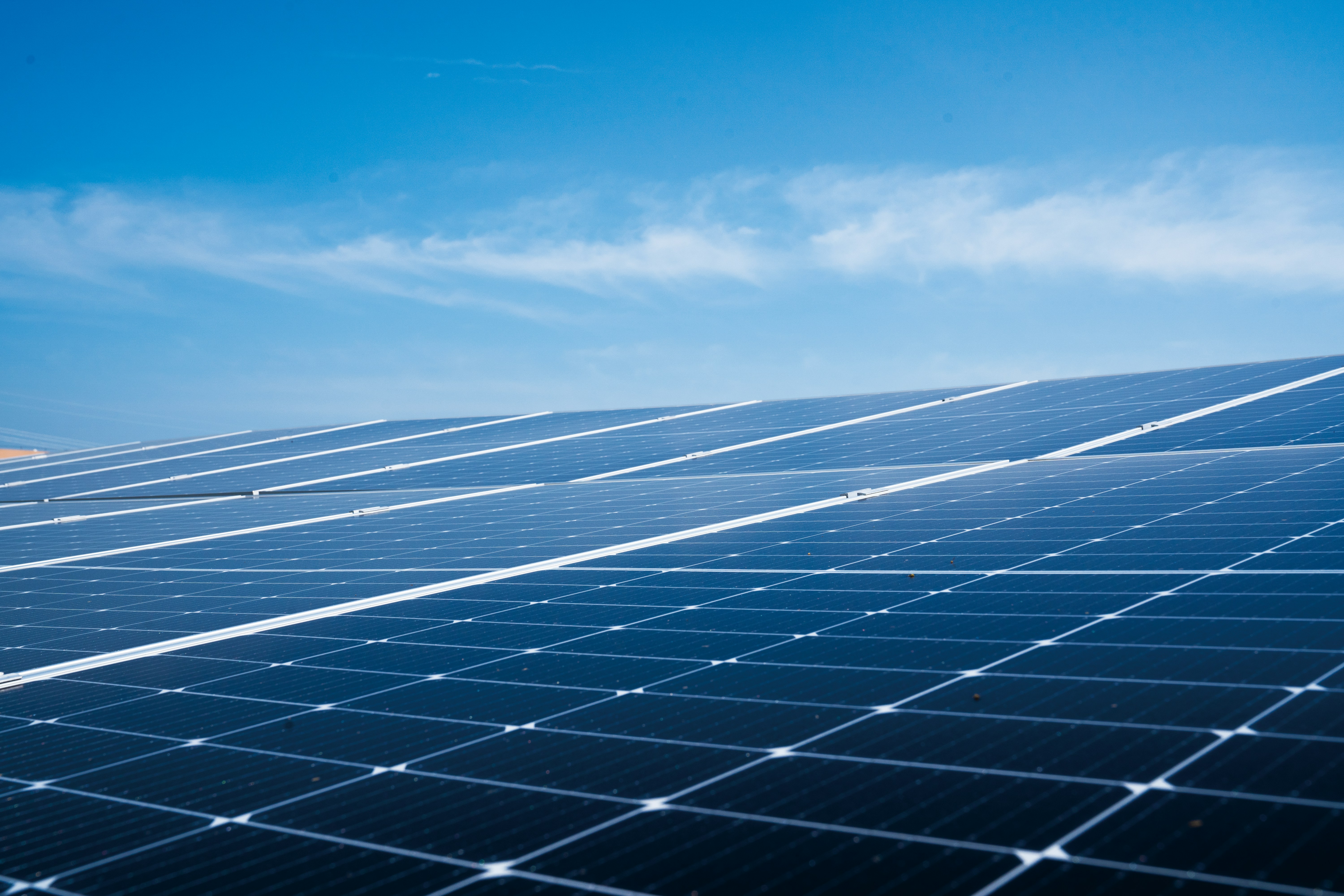 A photo presenting rows of solar panels beneath a clear blue sky.