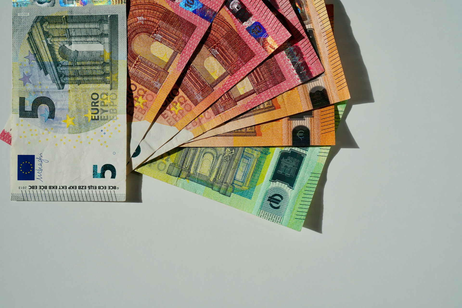 The photo presents different euro banknotes.