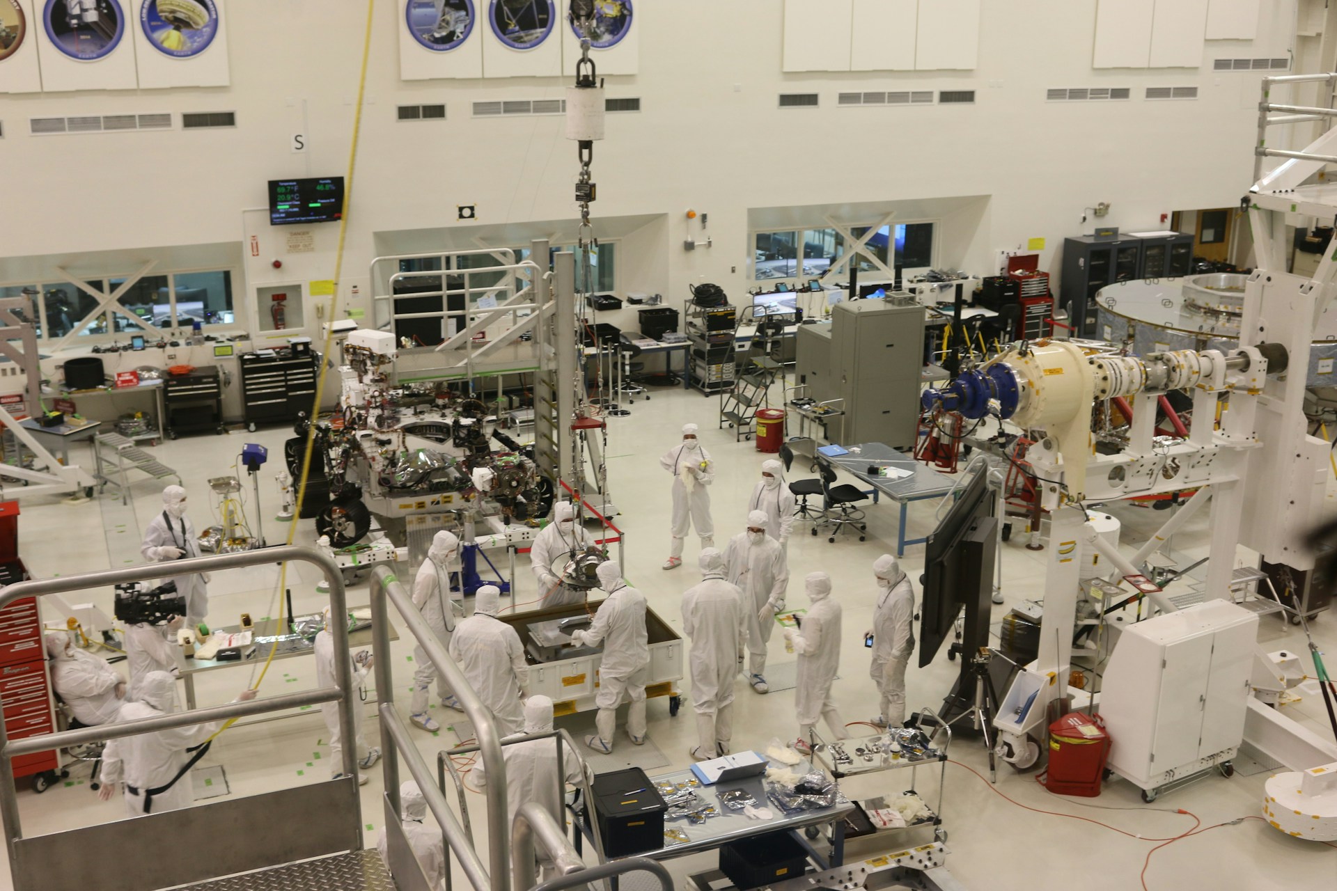 The photo presents engineers and technicians working inside a high-tech laboratory.