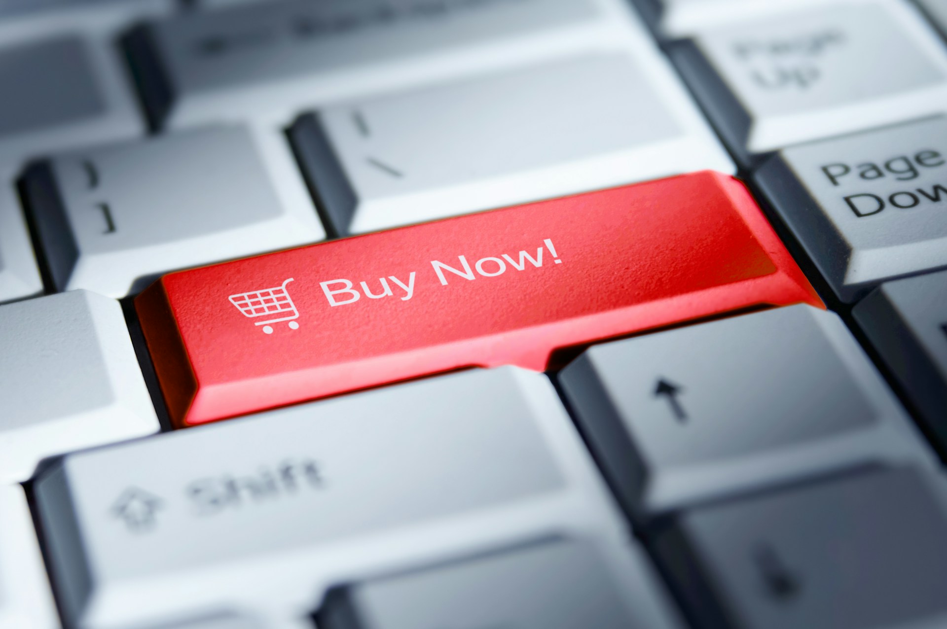 The photo presents a “Buy Now” button on a keyboard.