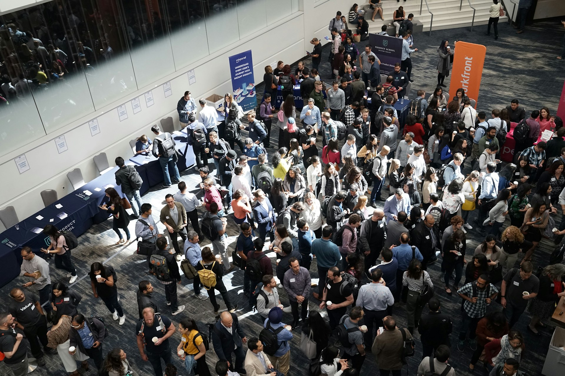 The photo presents a crowded networking event.