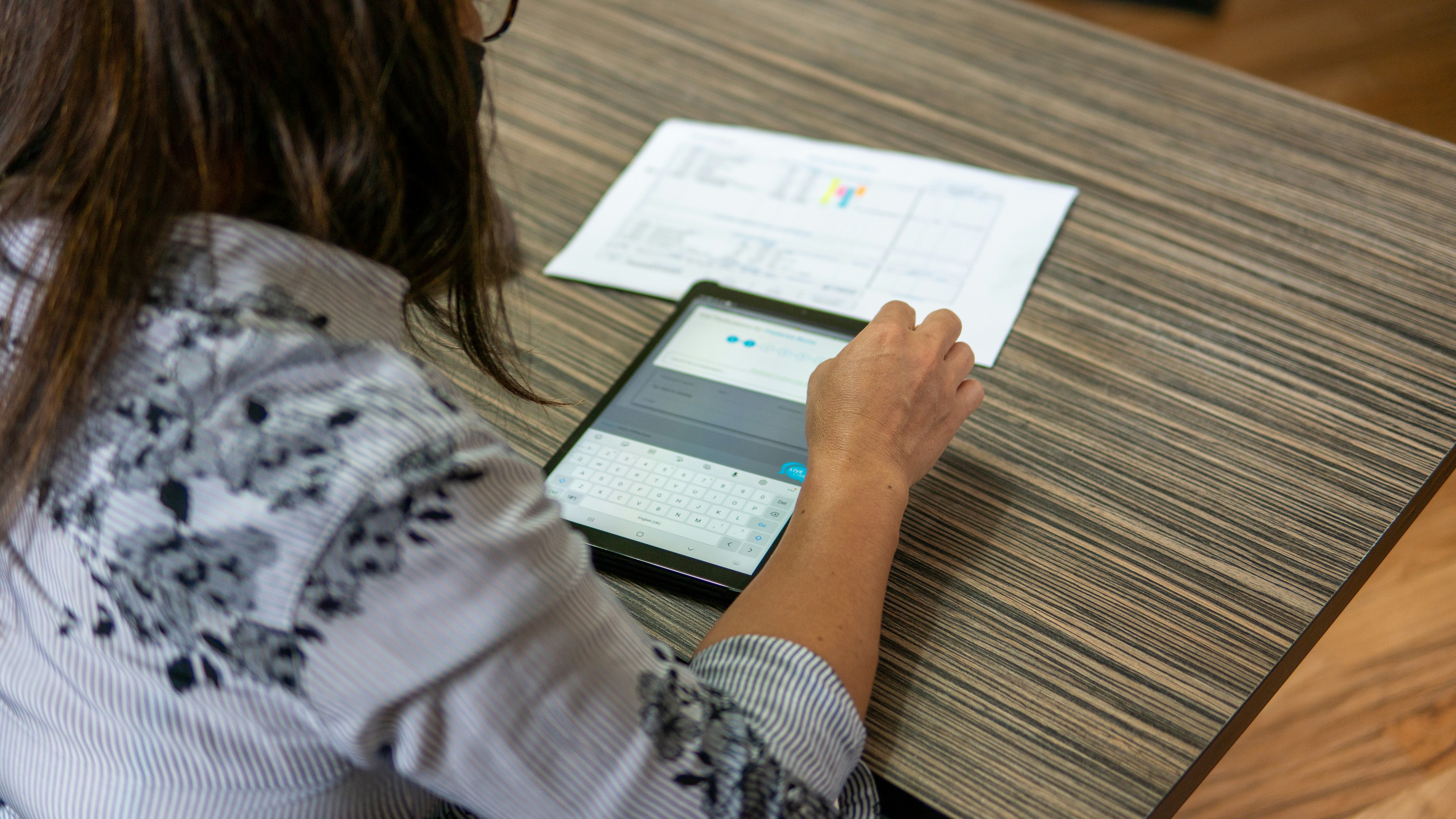 The photo shows lady using tablet.