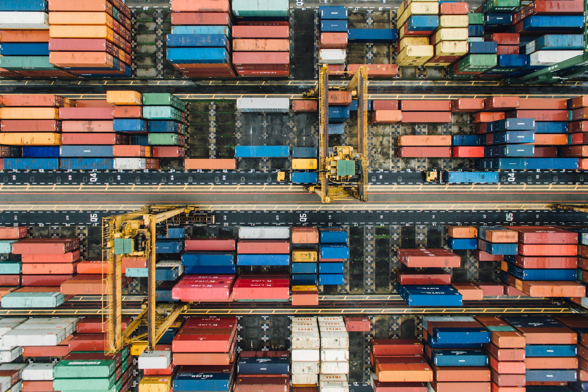 The photo presents shipping containers at a cargo terminal.