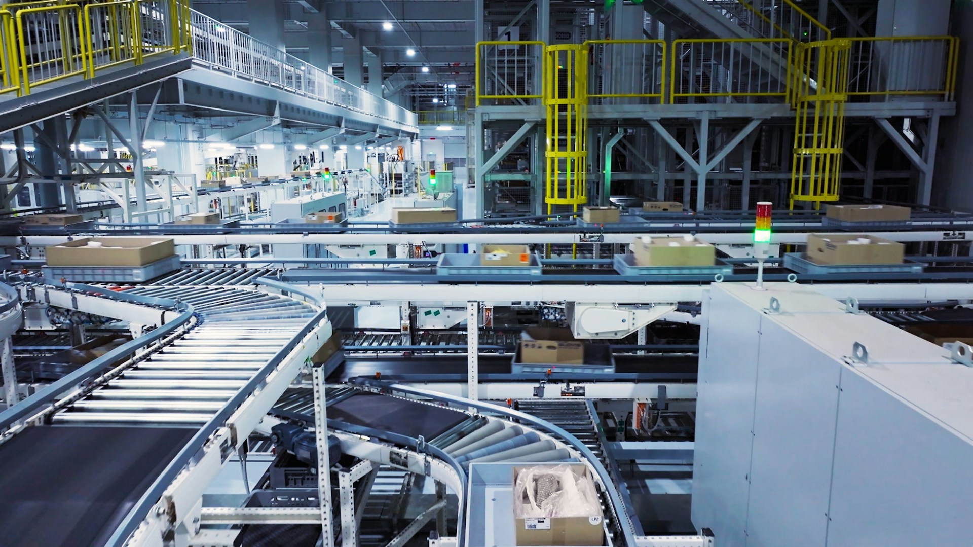 The photo presents an automated factory conveyor system.