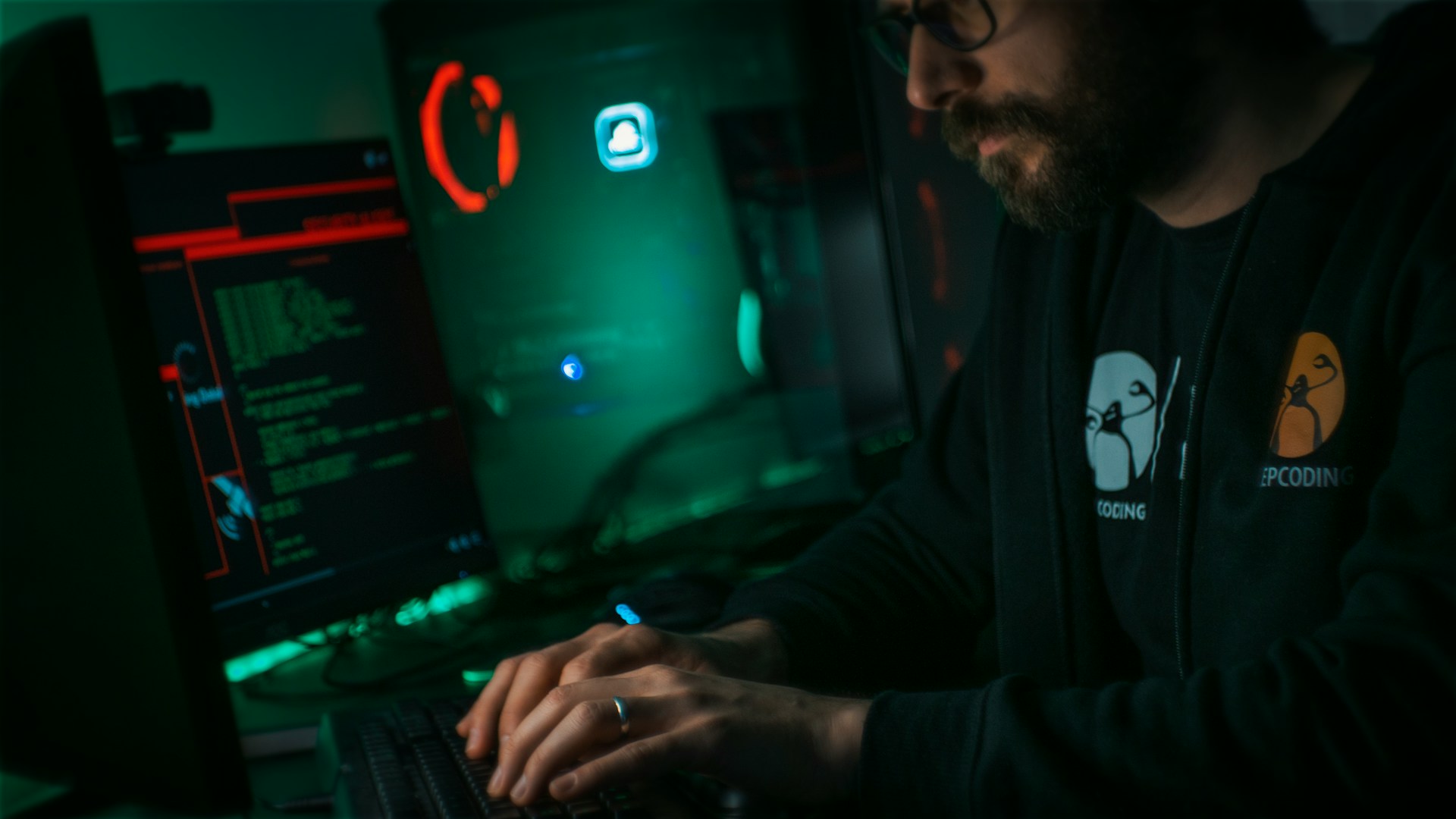 The photo presents a person working on cybersecurity at a computer.