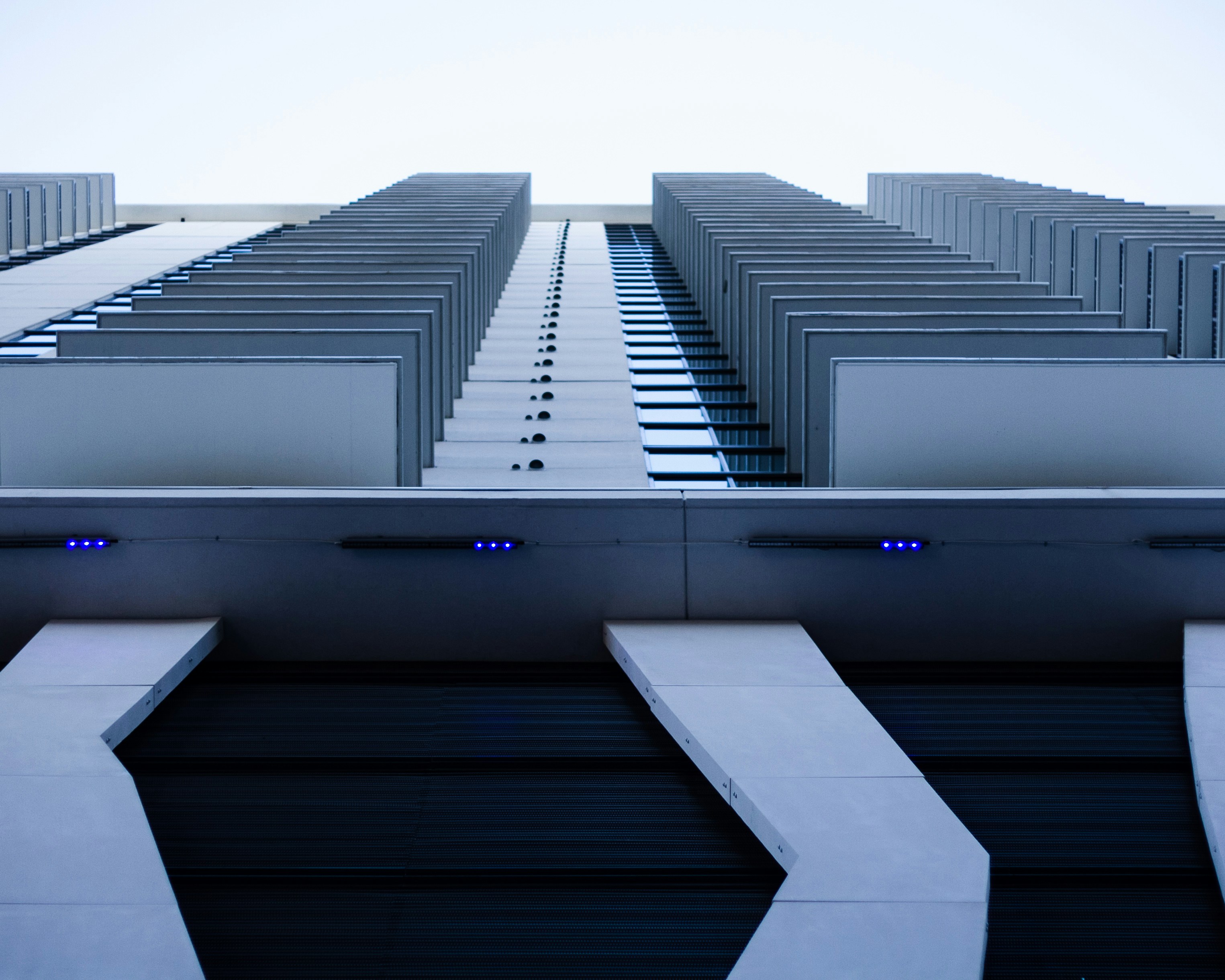 The picture describes a modern high-rise building viewed from below.