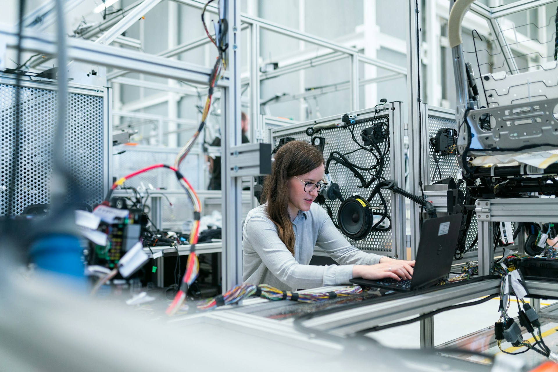 The photo presents an engineer working on a laptop.