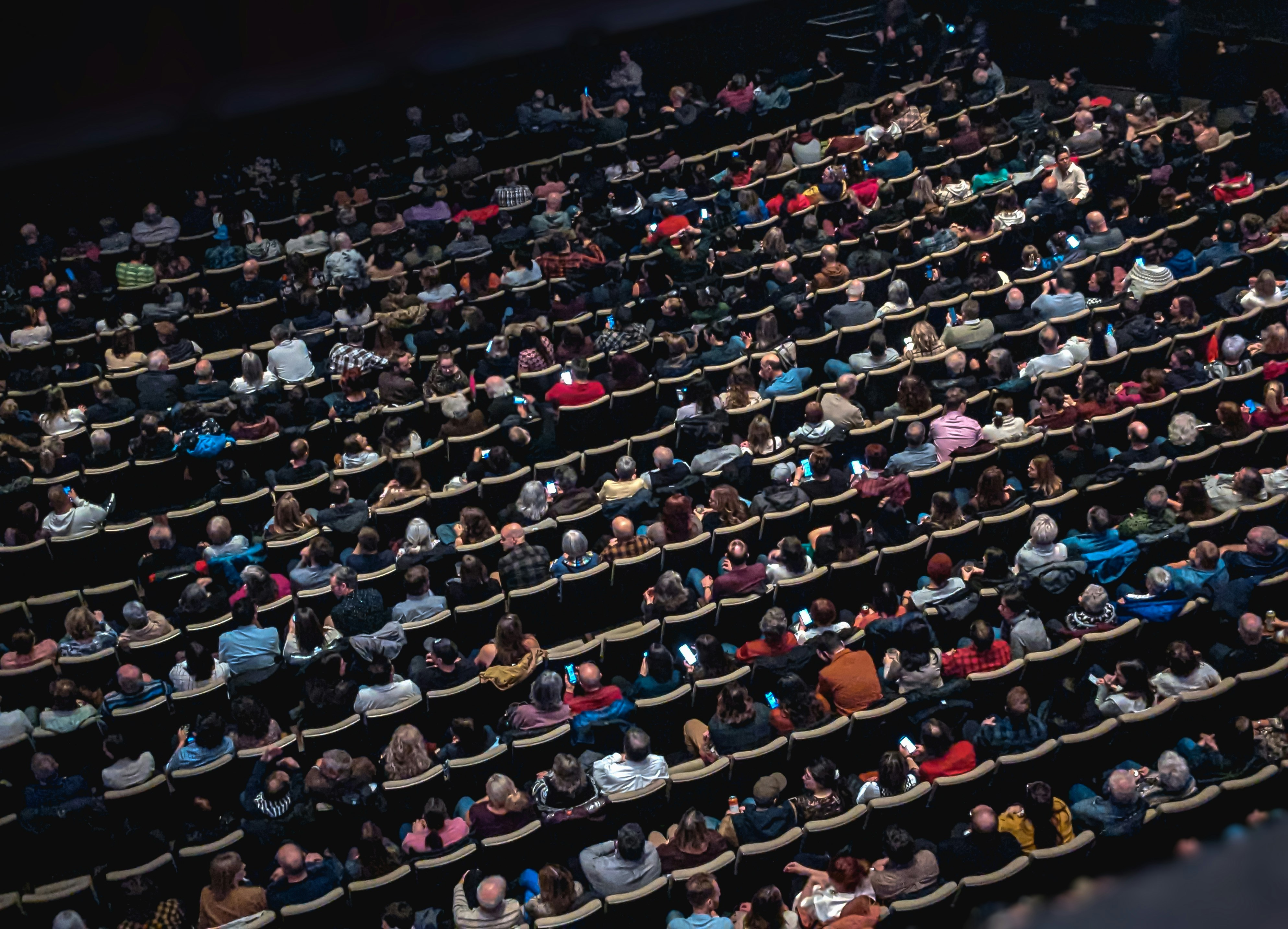 A large group of people sitting in a theatre.