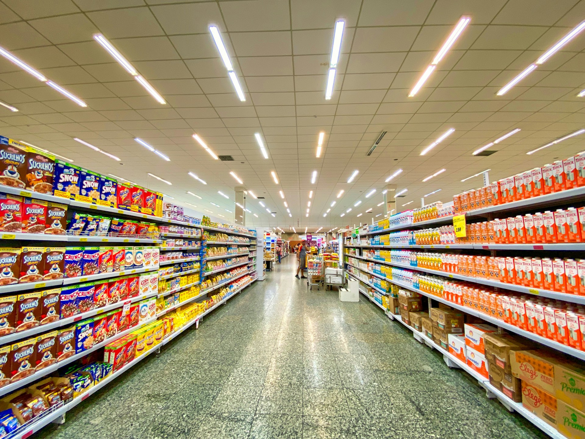 The photo presents a supermarket aisle filled with food products.