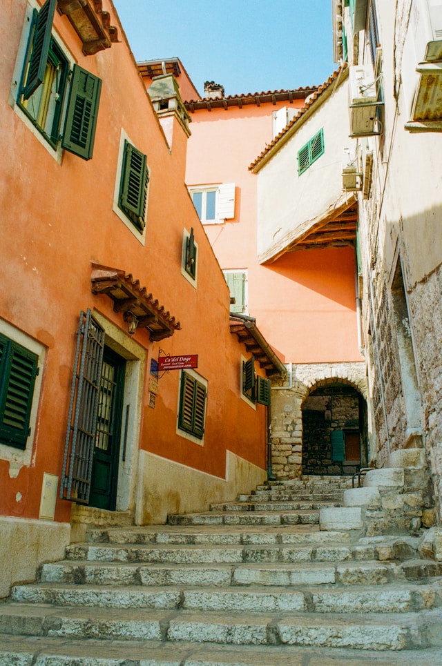 Photo by Unsplash An illustrative photo of a coastal town with terracotta-roofed buildings and a marina