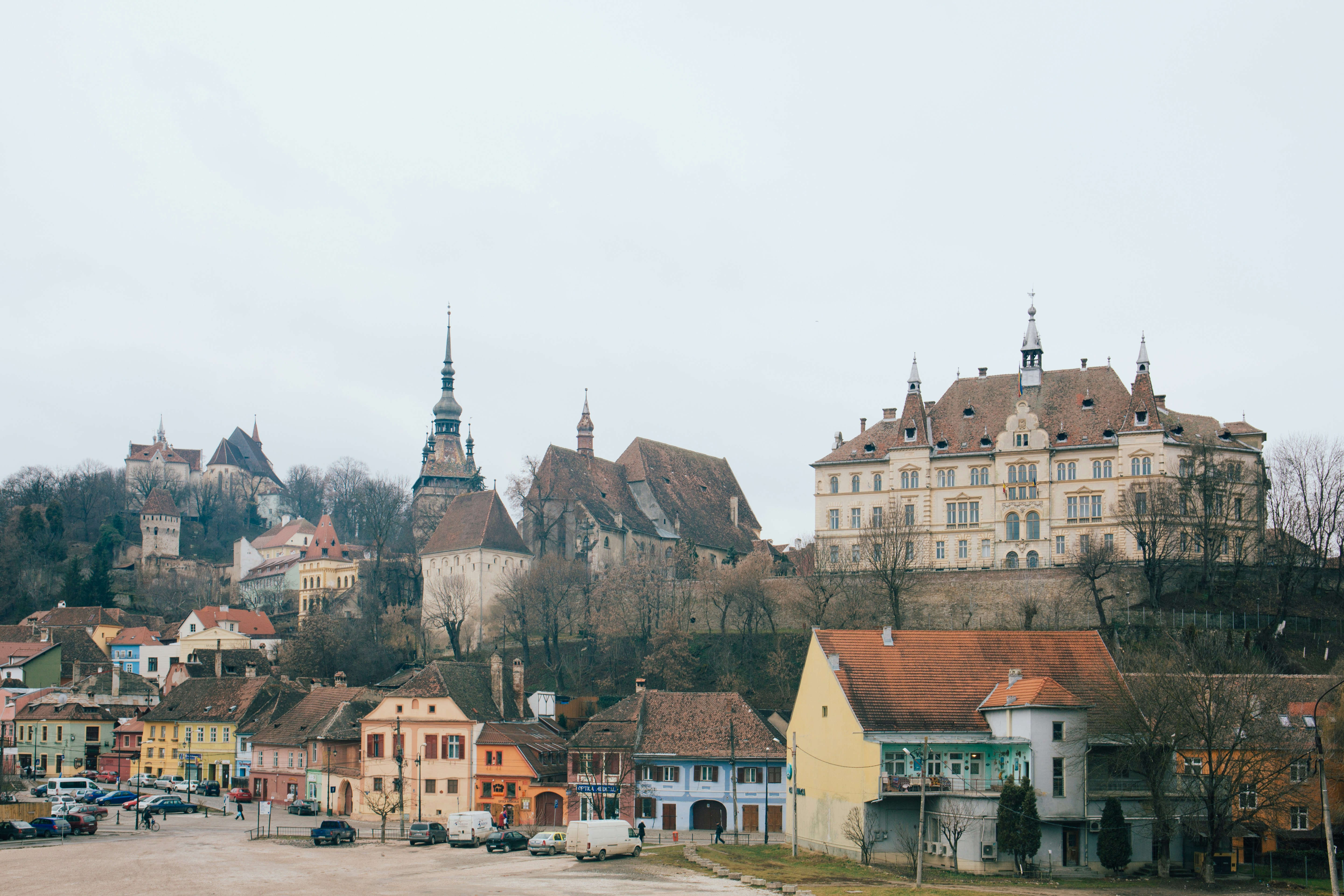 An illustrative photo of beige and brown gothic building on hill