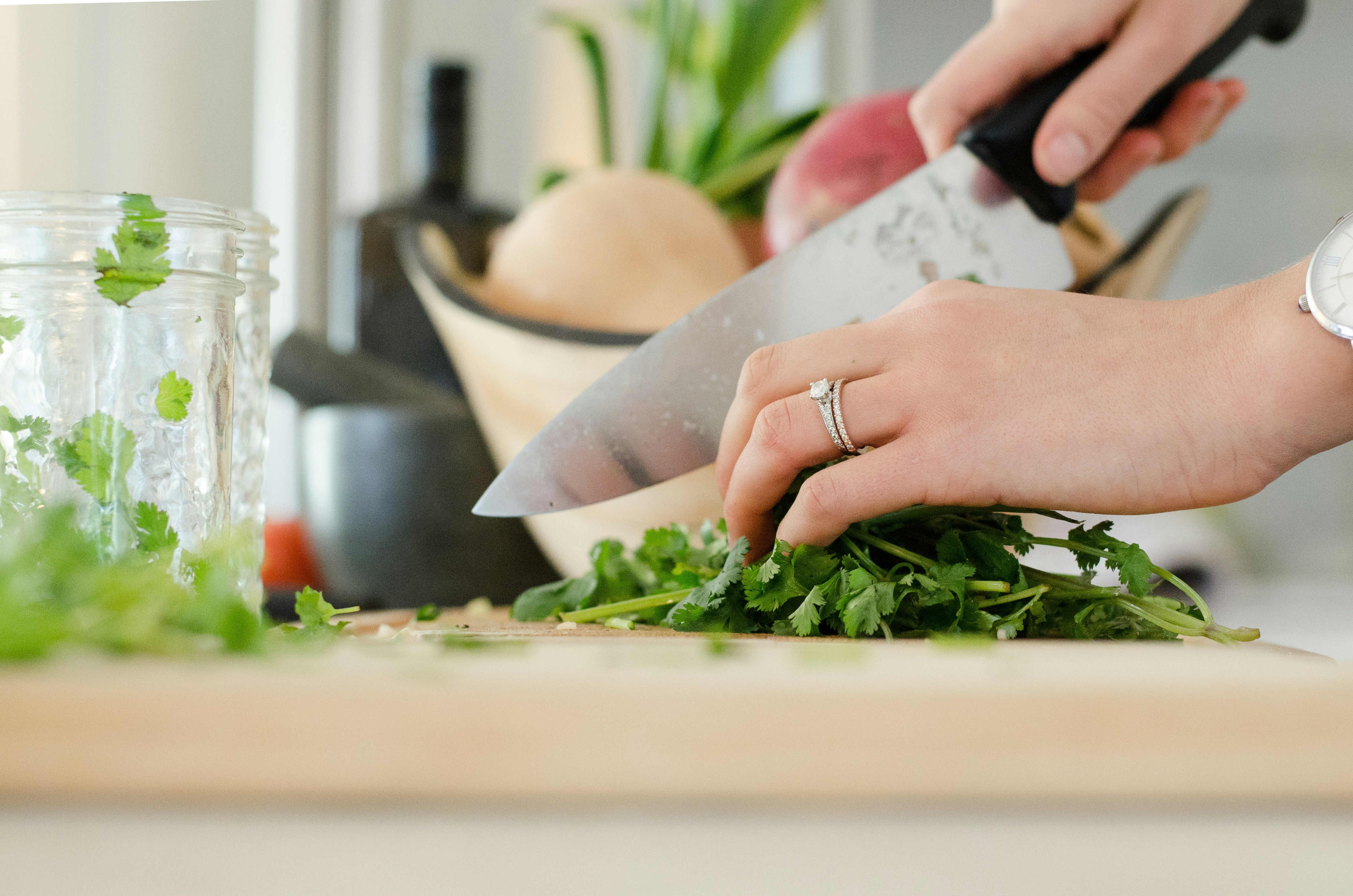 An illustrative photo of a person cutting parsley