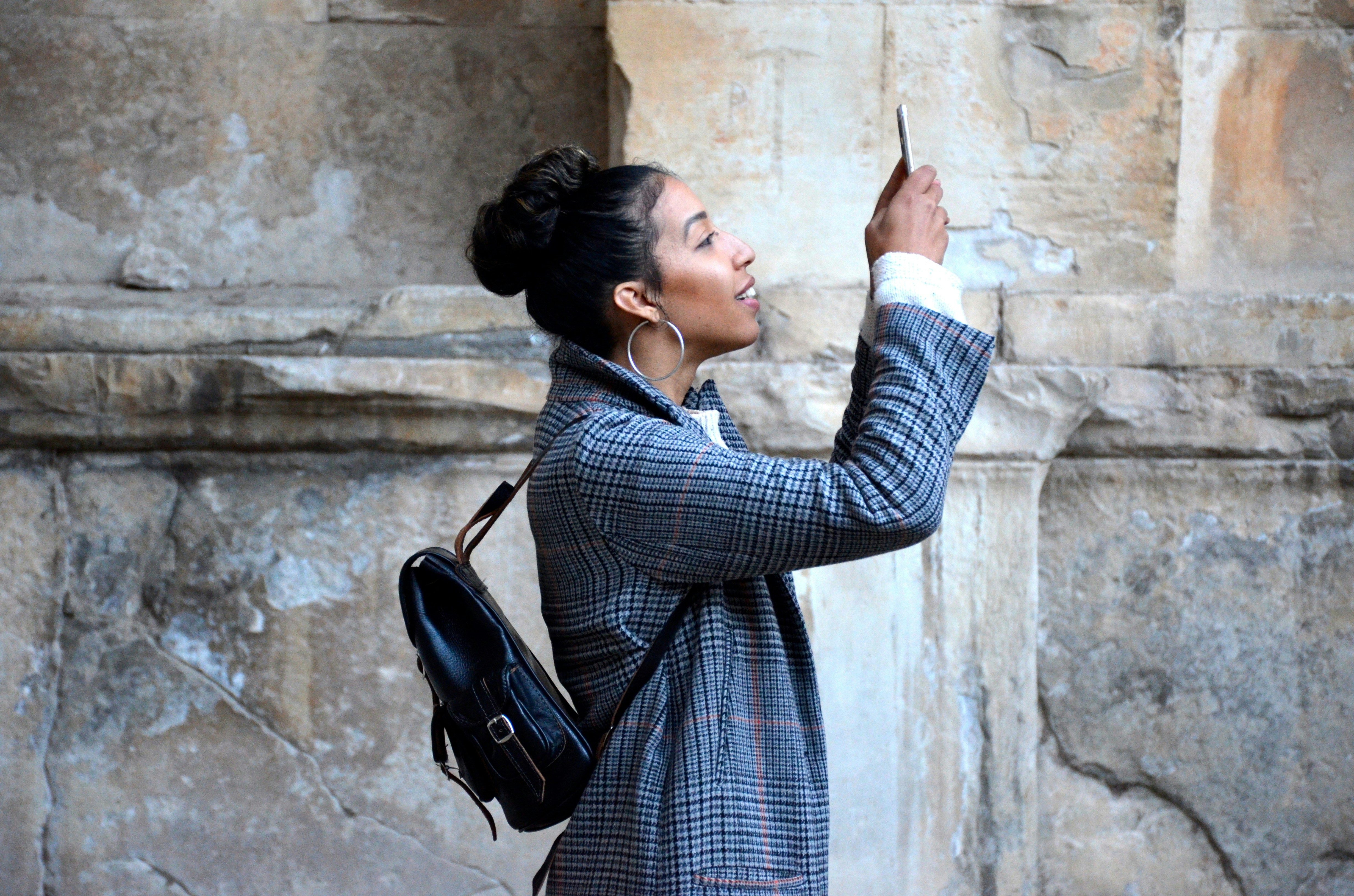 An illustrative photo of an person standing in front of a wall.