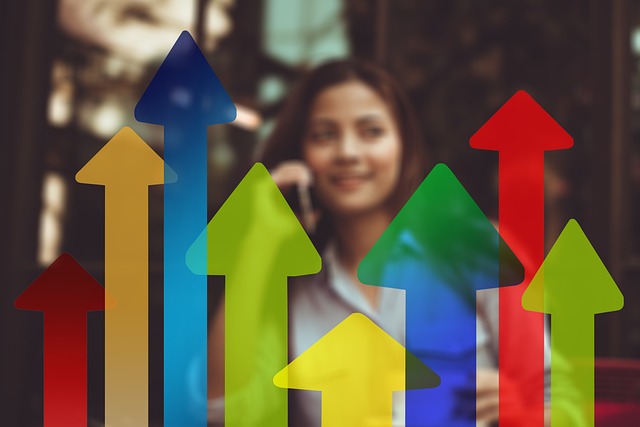 An illustrative photo of multicolored arrows with businesswoman in the background