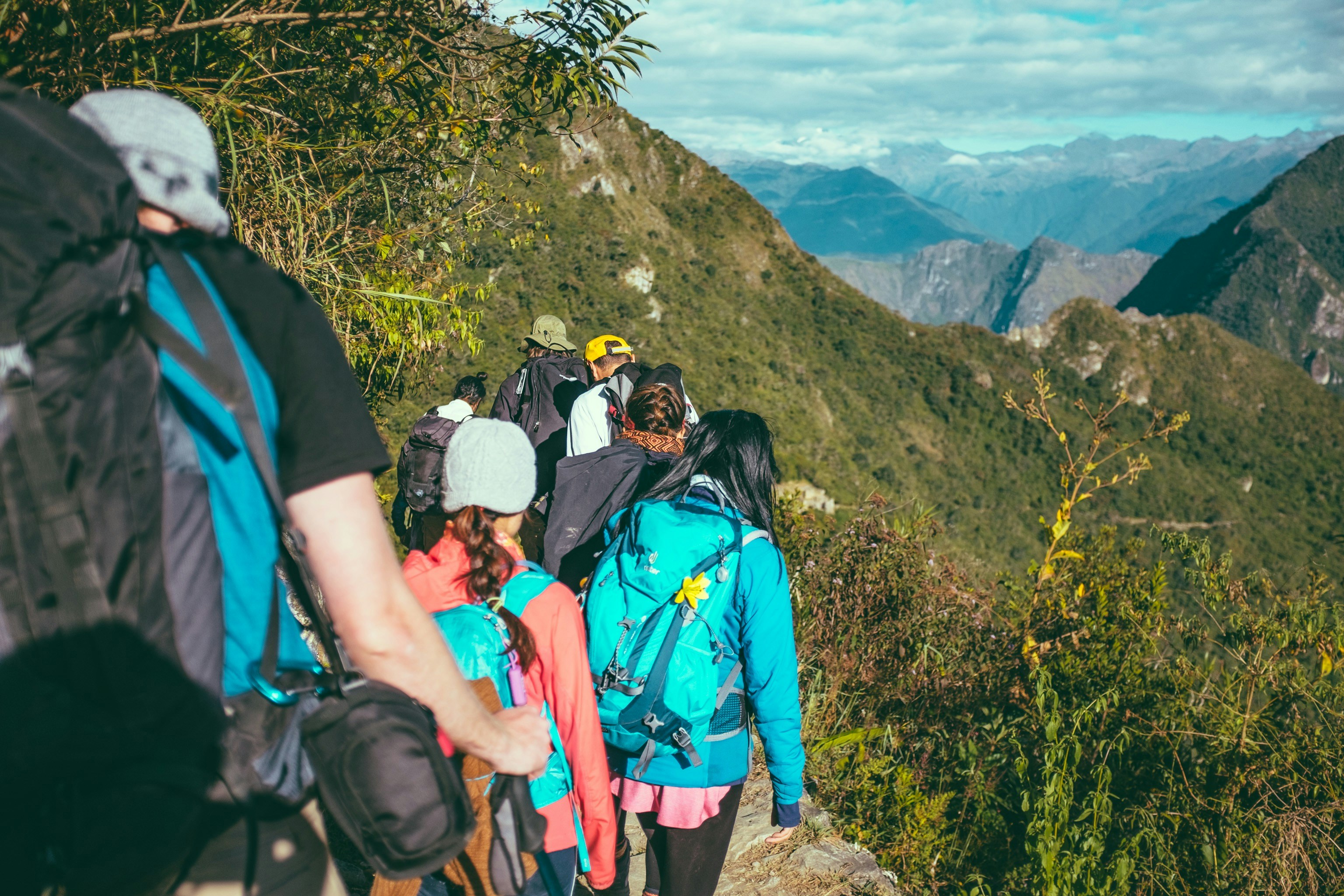 An illustrative photo of people walking beside the mountain