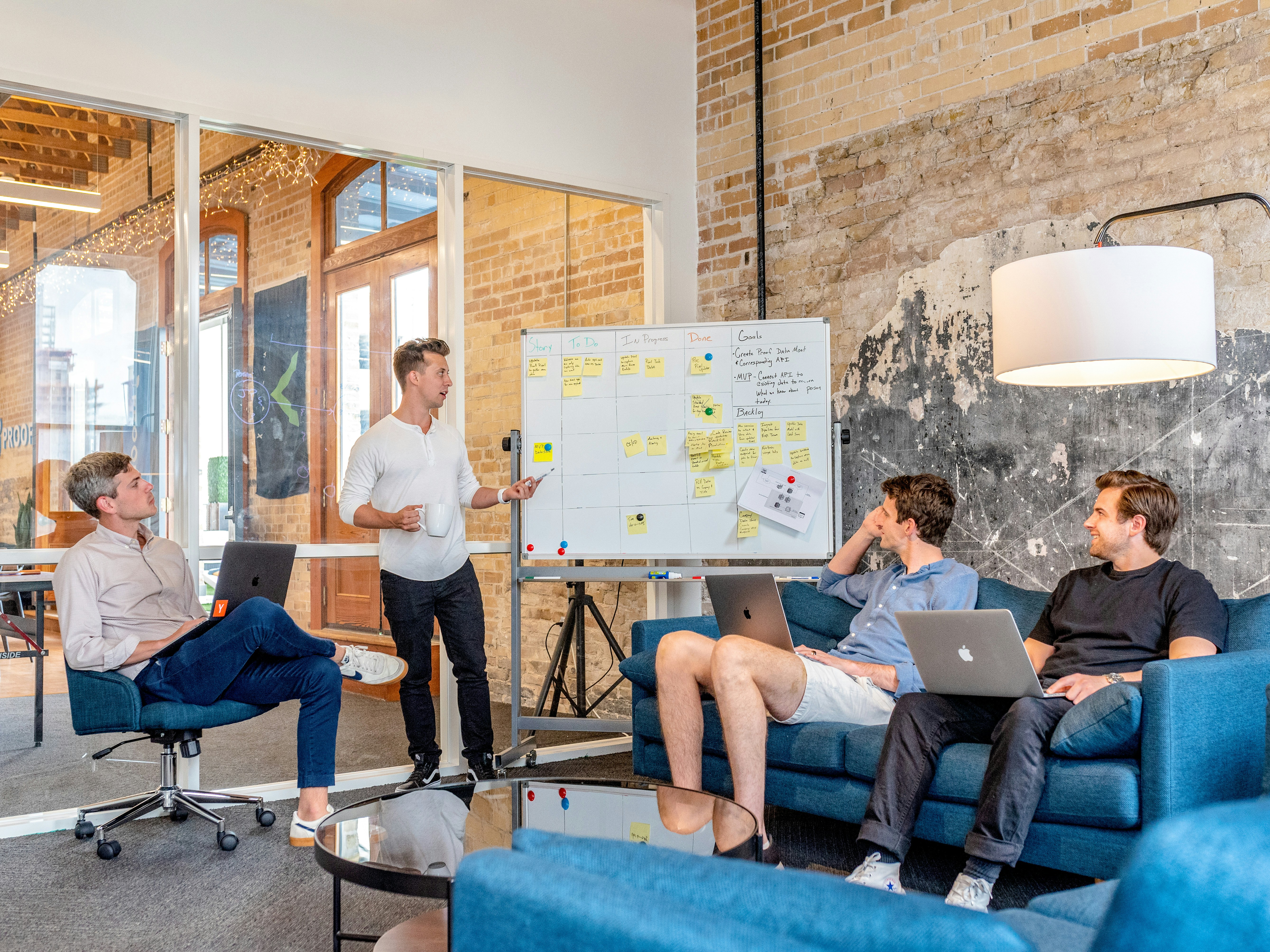 An illustrative photo of three men sitting and using laptops