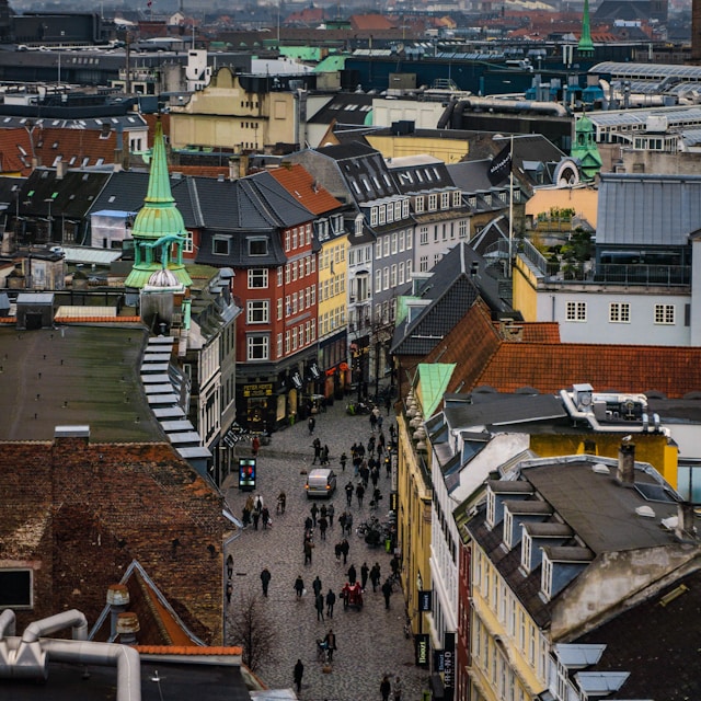 Photo by Unsplash An illustrative photo of people walking along a pathway between buildings