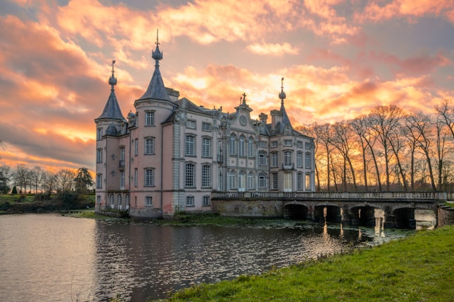 An illustrative photo of a concrete building near a body of water. during the daytime