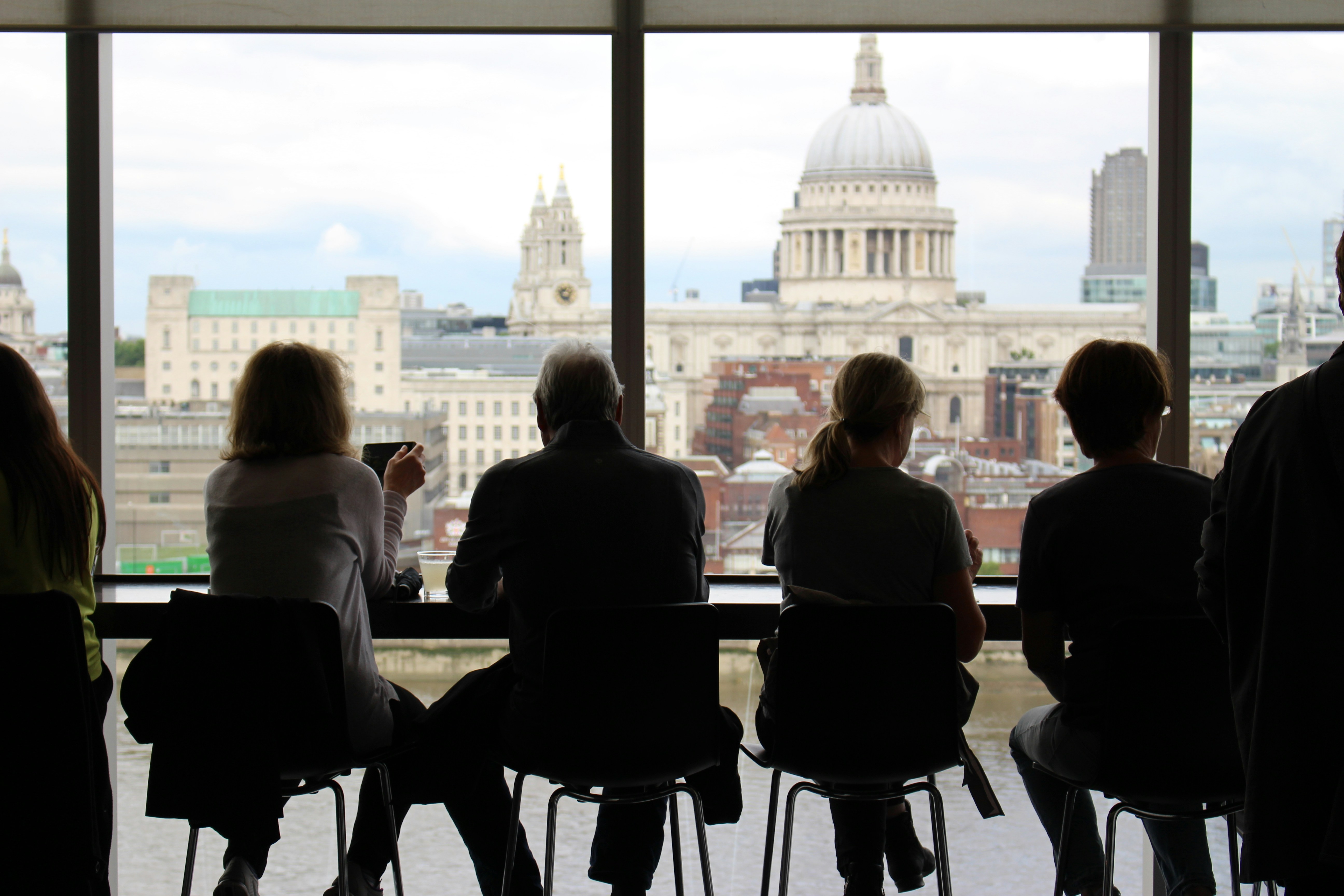 Photo by Unsplash An illustrative photo of a man sitting among four women