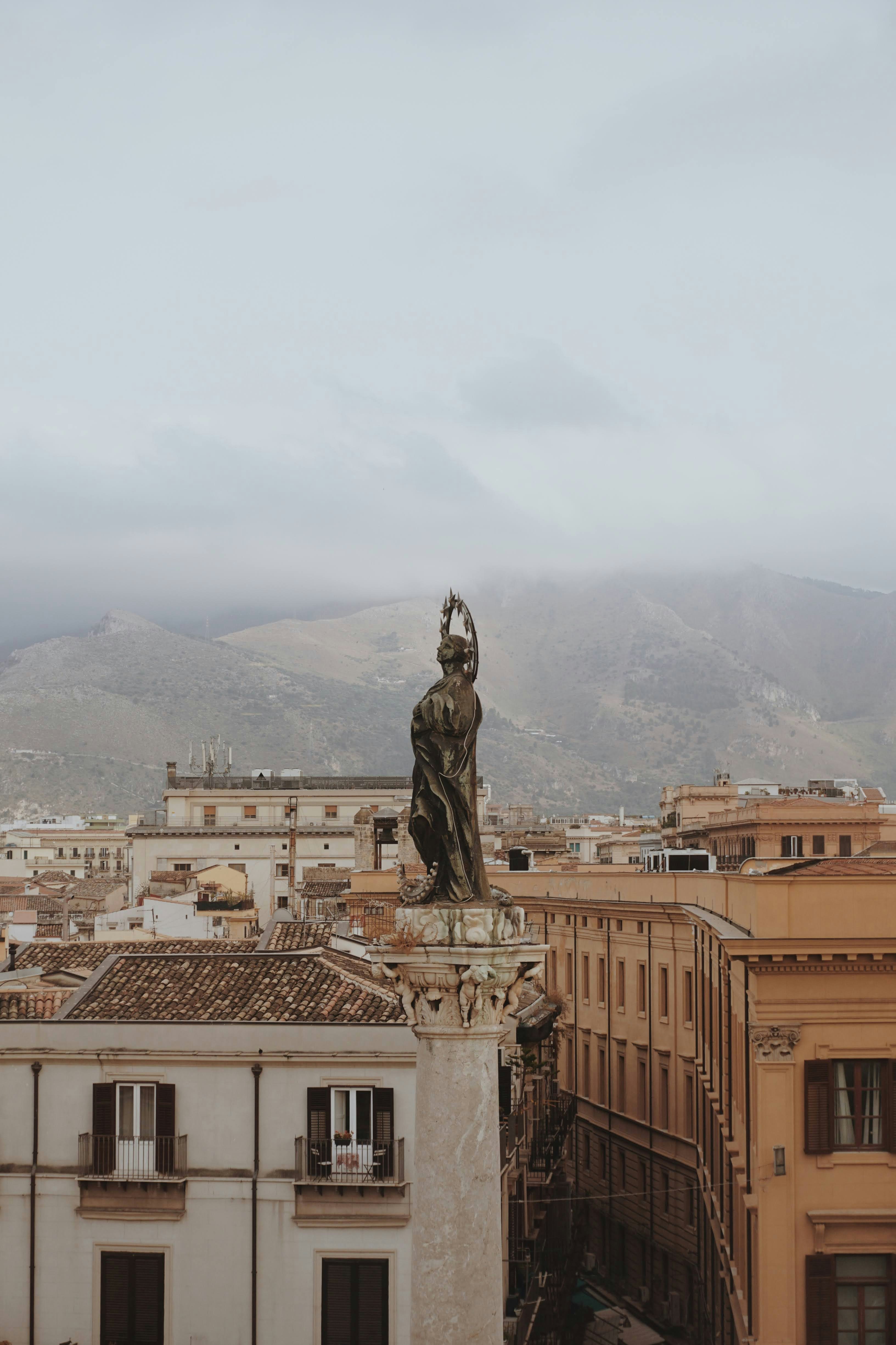 An illustrative photo of a statue of man on top of building