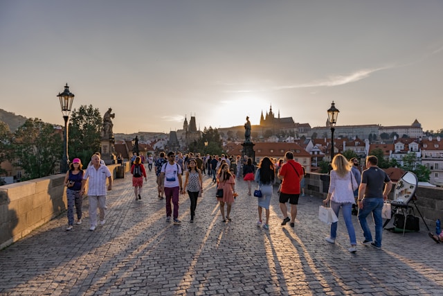 An illustrative photo of people walking on Charles bridge in Czech Republic