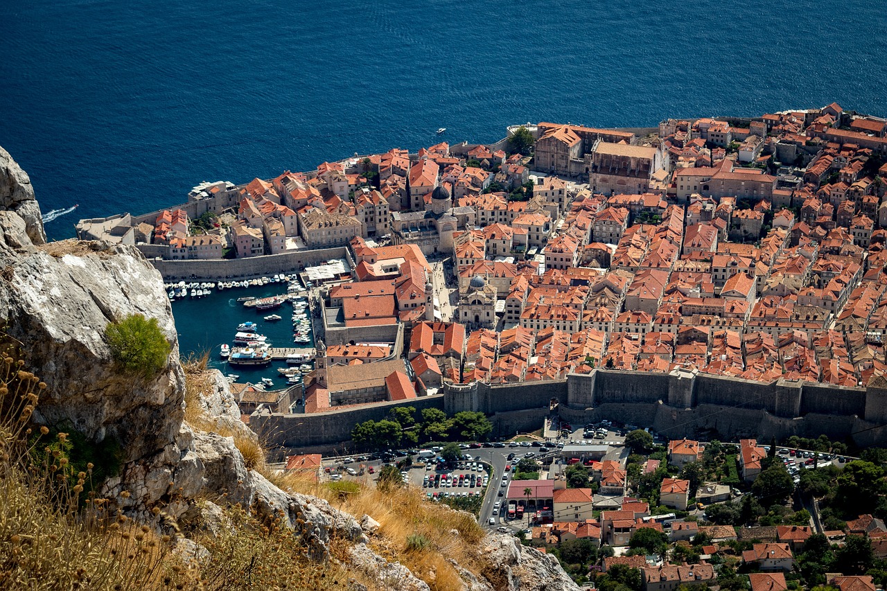 An illustrative photo of of a historic coastal town with terracotta rooftops