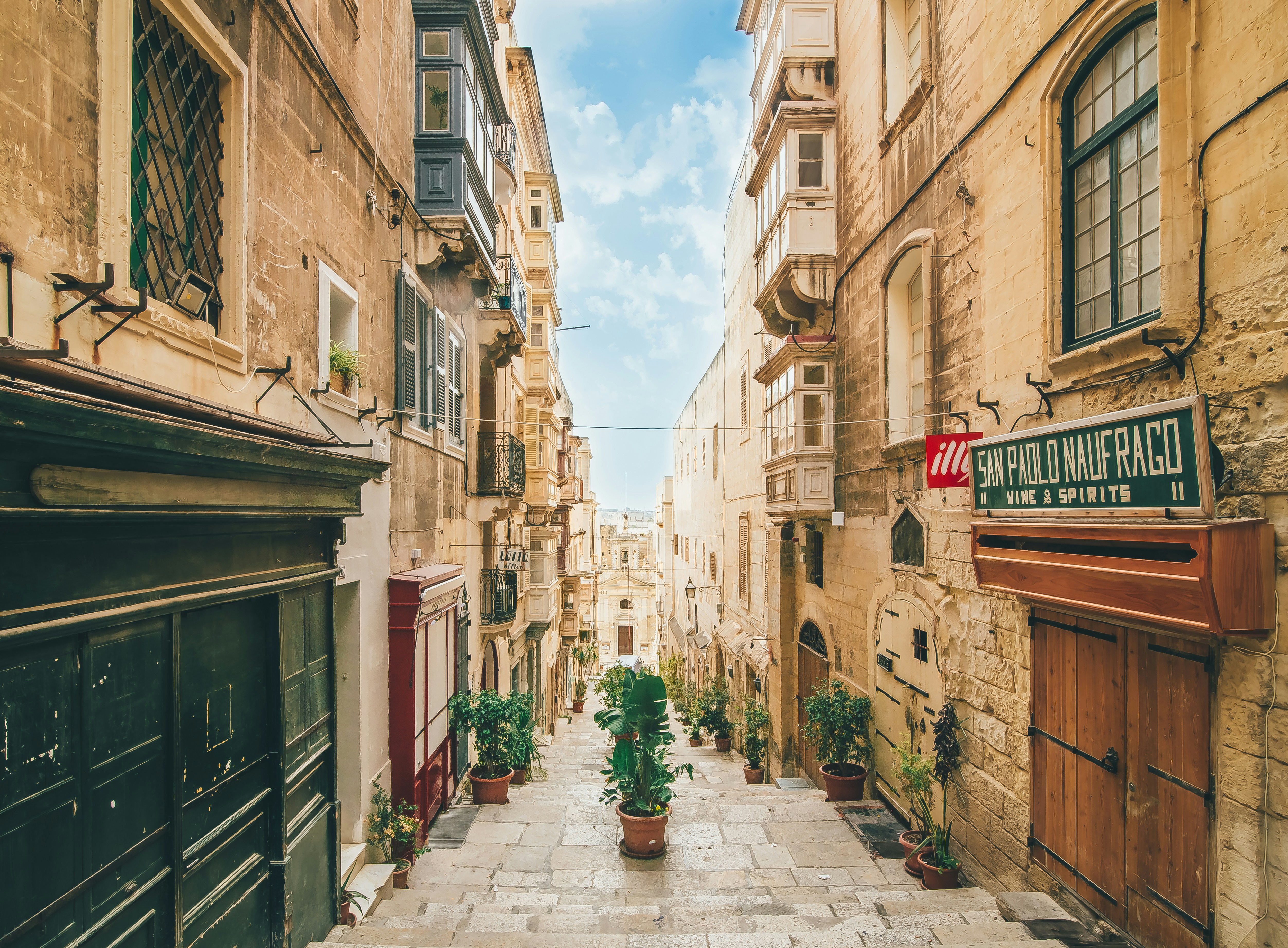 An illustrative photo of narrow concrete street under blue sky
