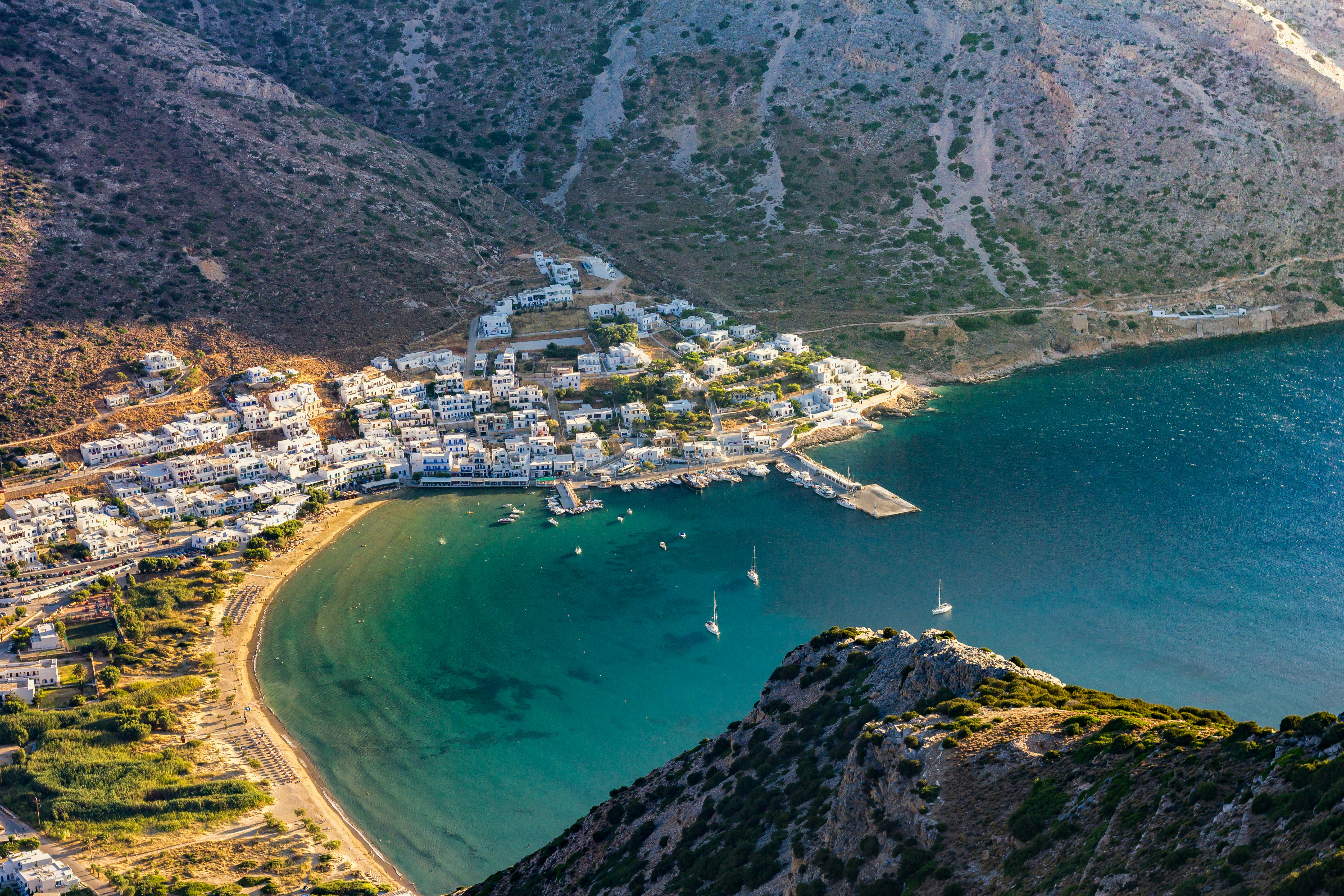 An illustrative photo of a town beside sea on the foot of the mountain.