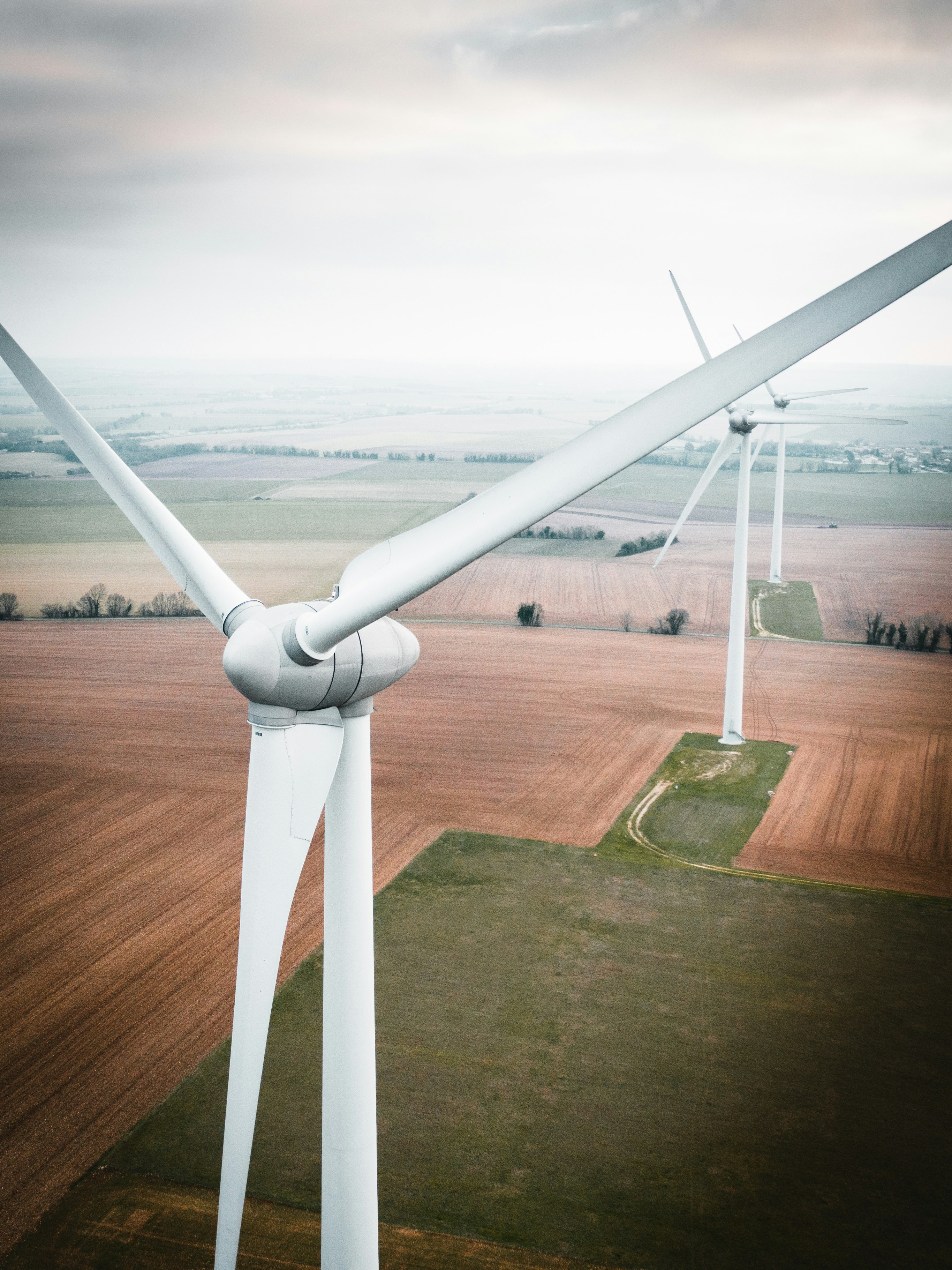 An illustrative photo of three windmills in the field